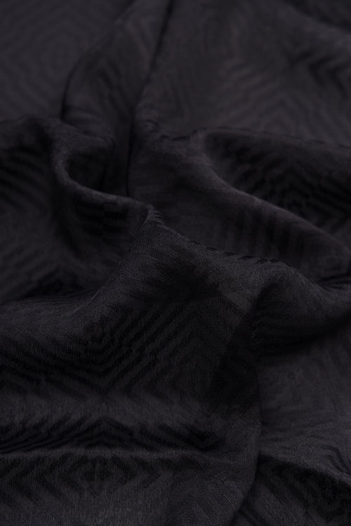 Close up of Black Dual Tone Mysore Georgette Saree with Jacquard design on the body and Zari Border.  displaying folds