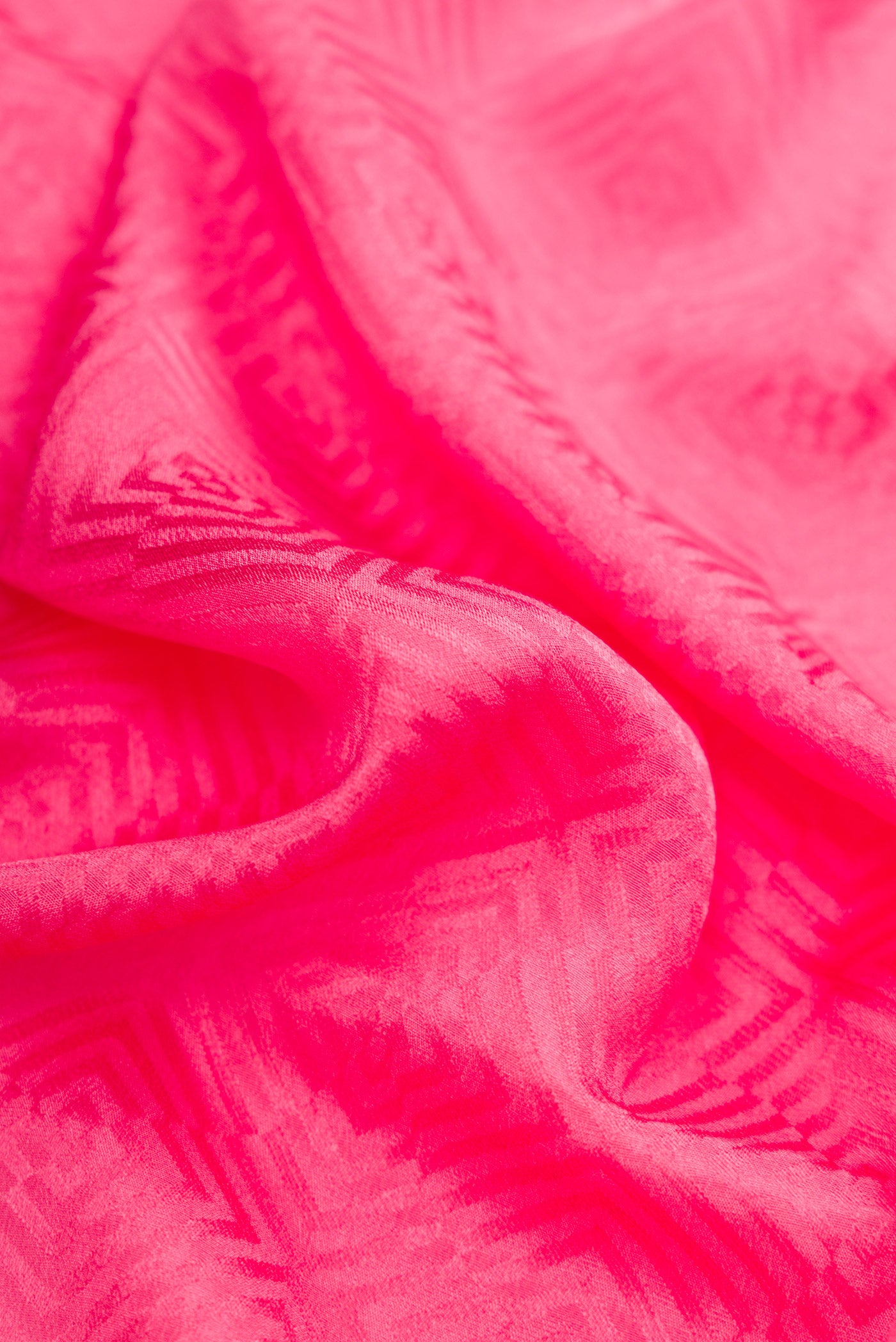 Close up of Pink Dual Tone Georgette Saree with Jacquard design on the body and Zari Border.  displaying folds
