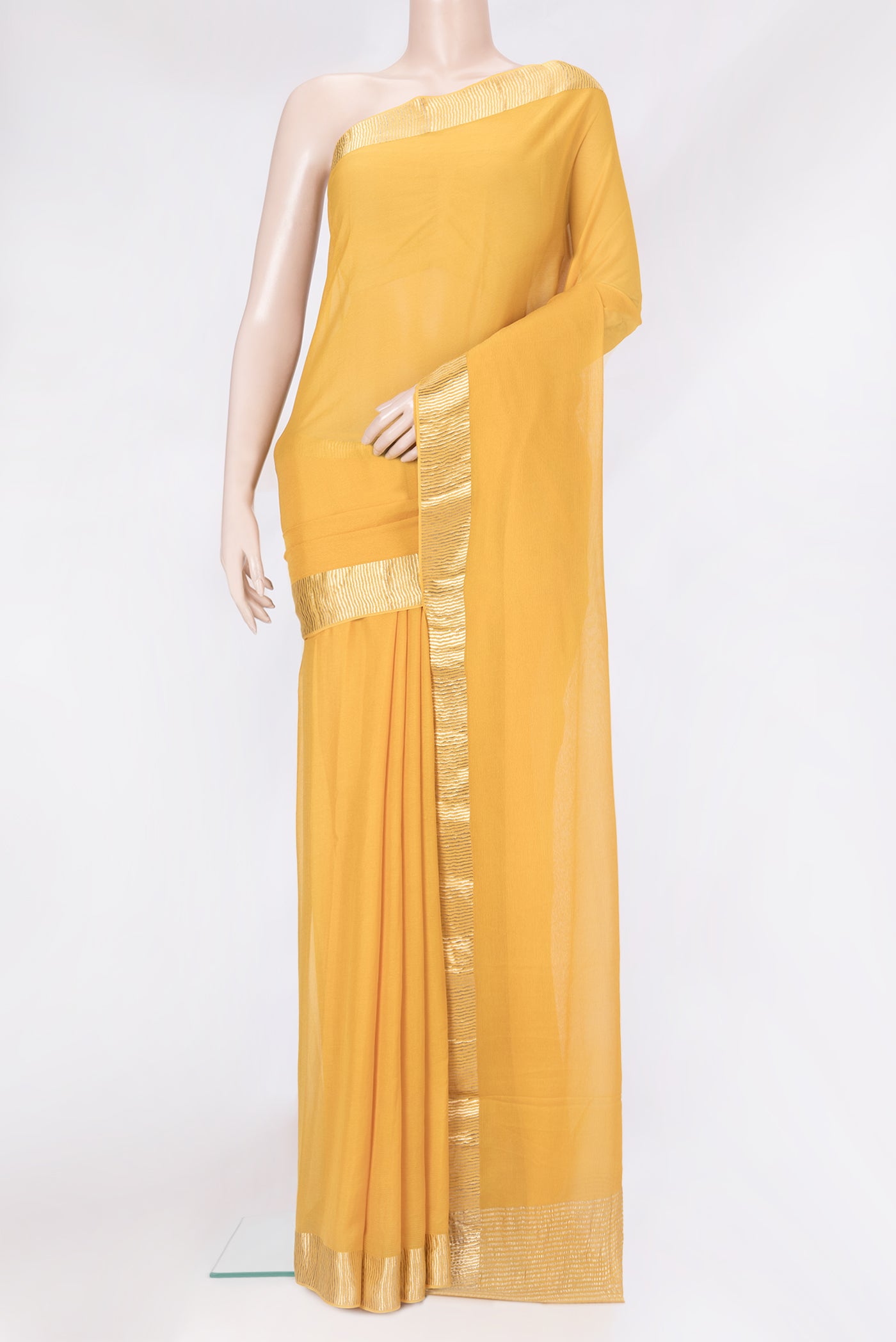 Mustard Mysore Chiffon Saree with Plain Body and Zari Border.  displayed on a mannequin