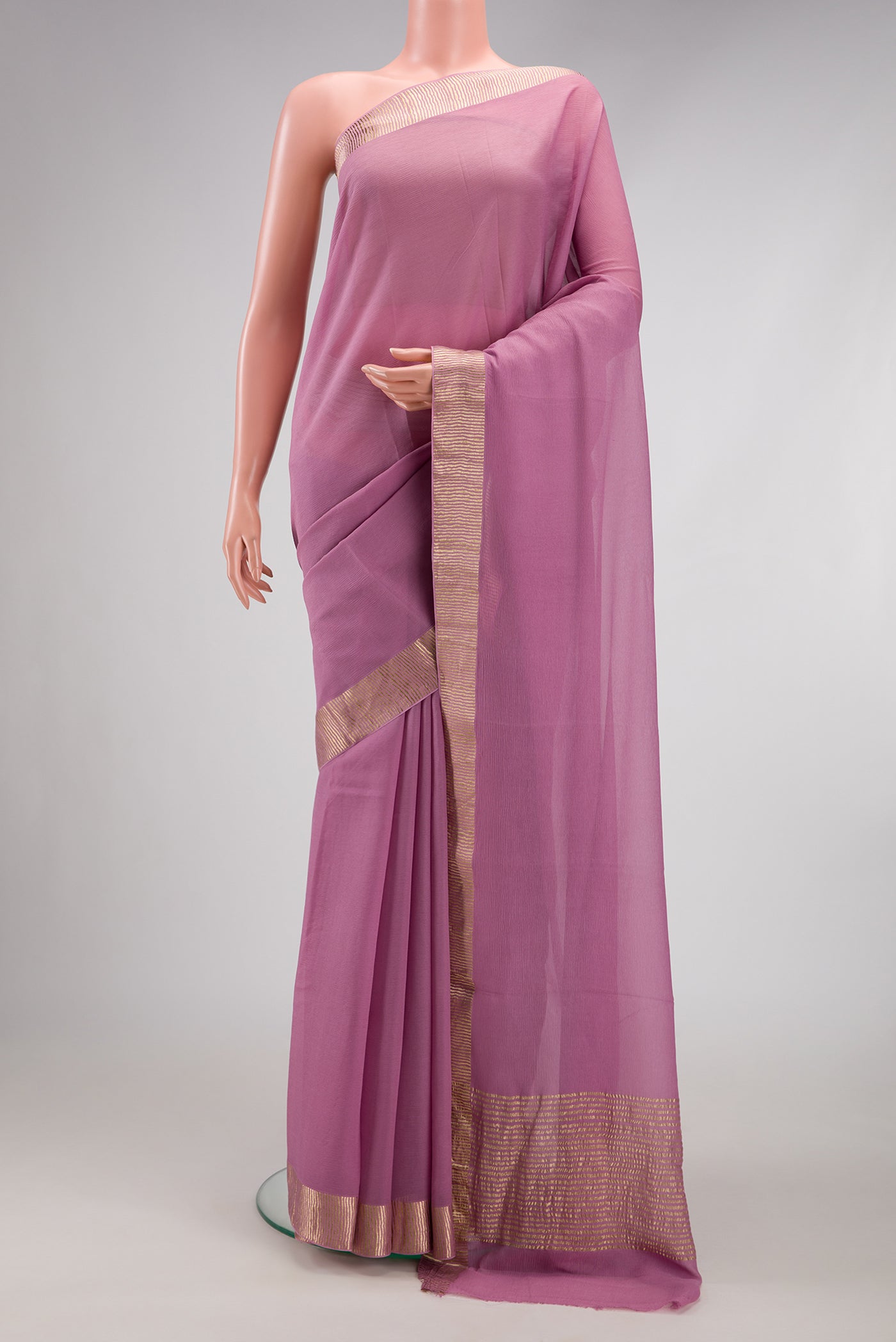 Lavender Chiffon Saree with Plain Body and Zari Border.  displayed on a mannequin
