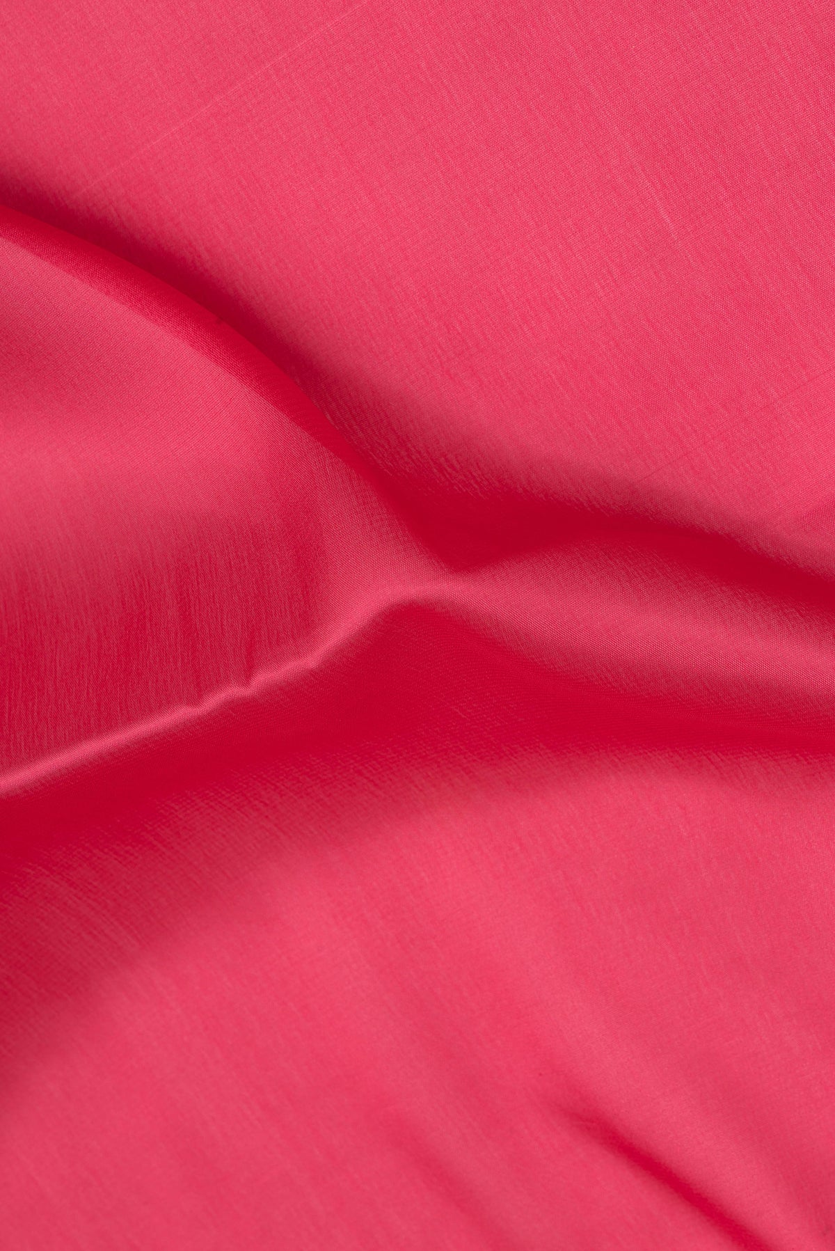 Close up of Imperial Red Mysore Silk Saree with Plain Body and Zari Border.  displaying folds