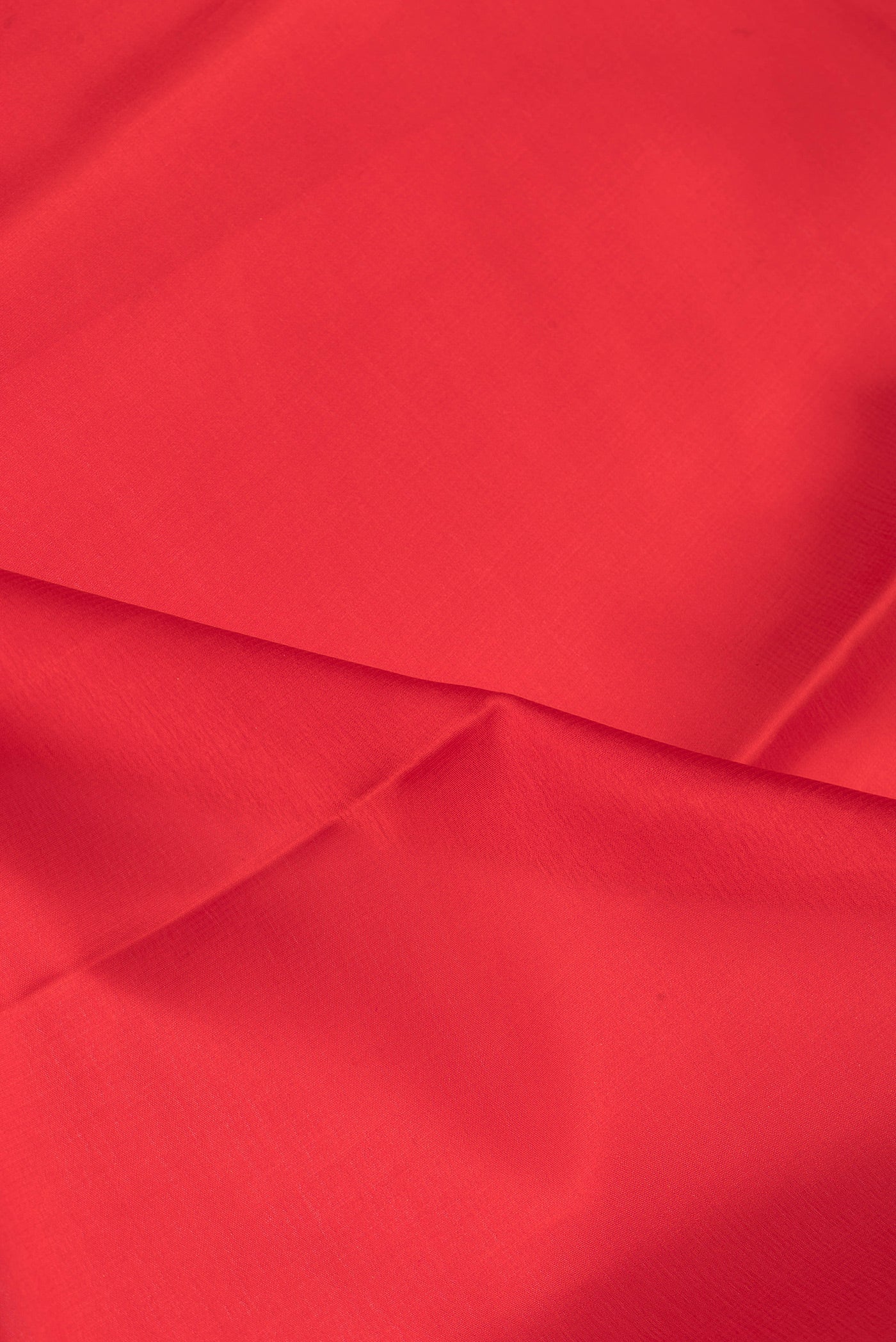 Close up of Red Mysore Silk Saree with Plain Body and Zari Border.  displaying folds