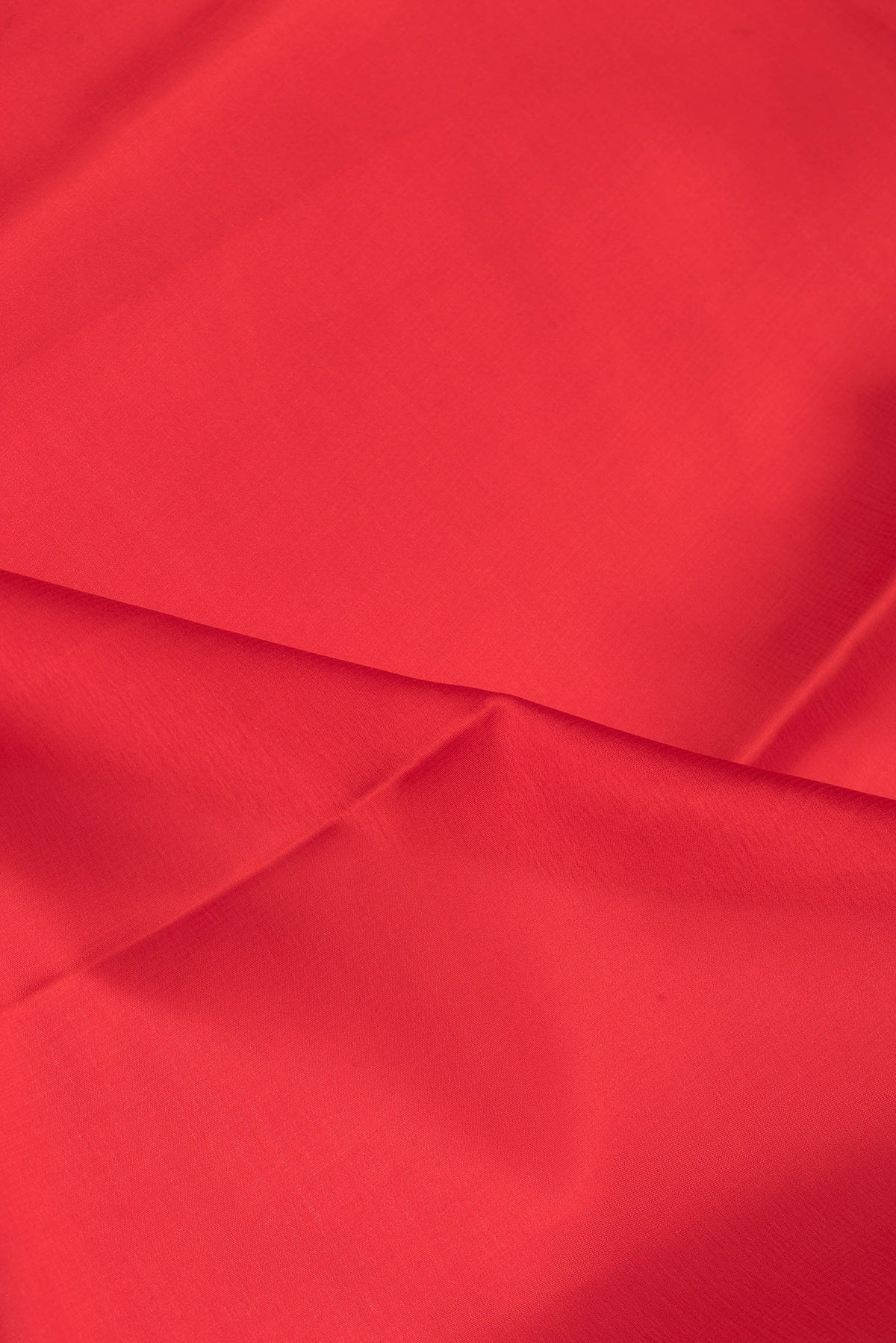 Close up of Red Mysore Silk Saree with Plain Body and Zari Border.  displaying folds