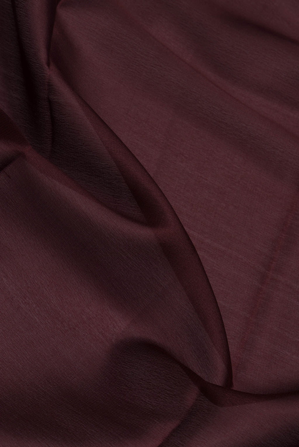 Close up of Coffee Brown Mysore Crepe Saree with Plain Body and Zari Border.  displaying folds