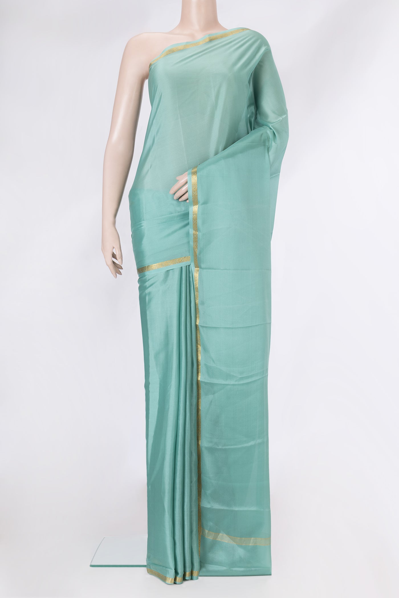 Sea Green Mysore Crepe Saree with Plain Body and Zari Border.  displayed on a mannequin