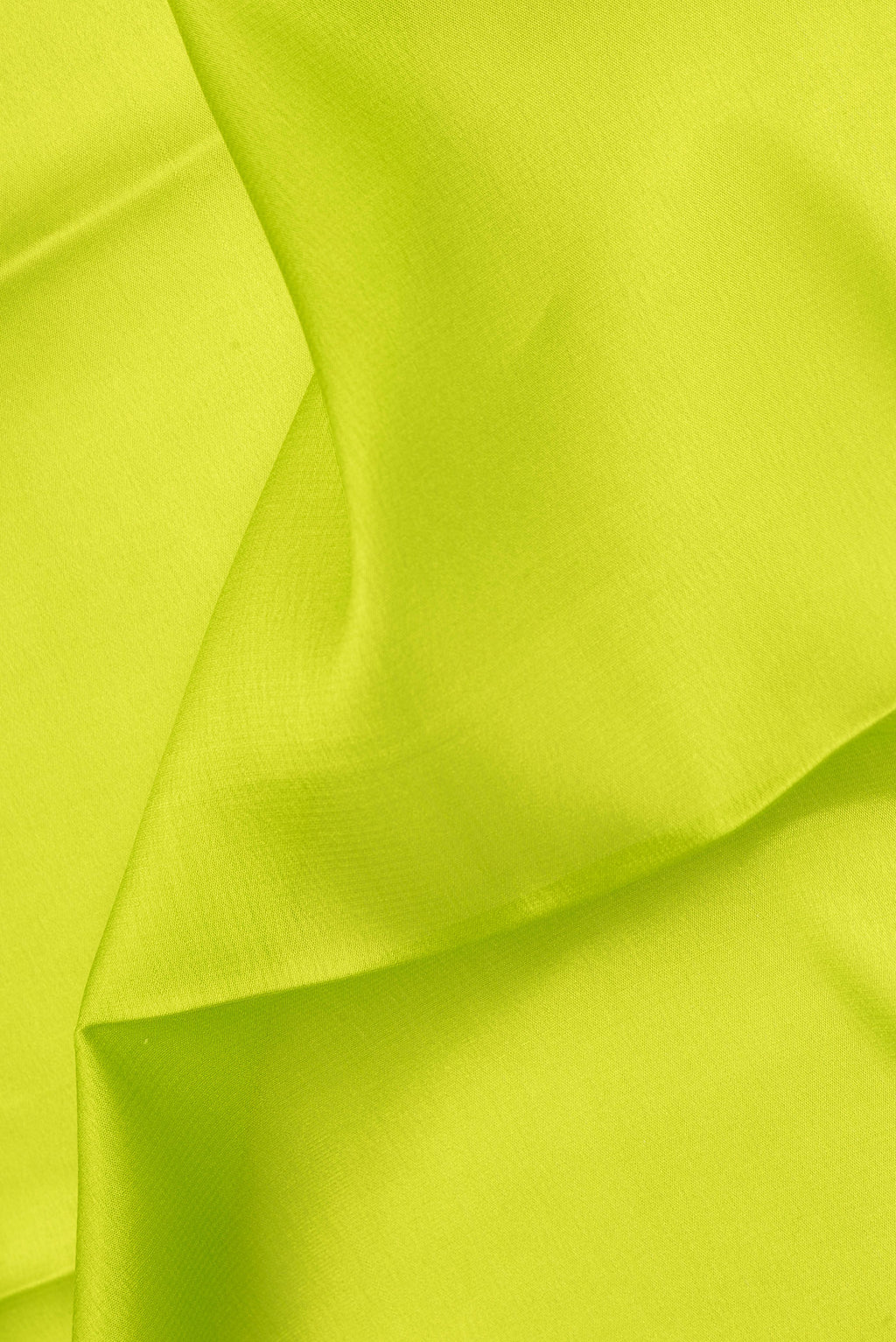 Close up of Parrot Green Mysore Crepe Saree with Plain Body and Zari Border.  displaying folds