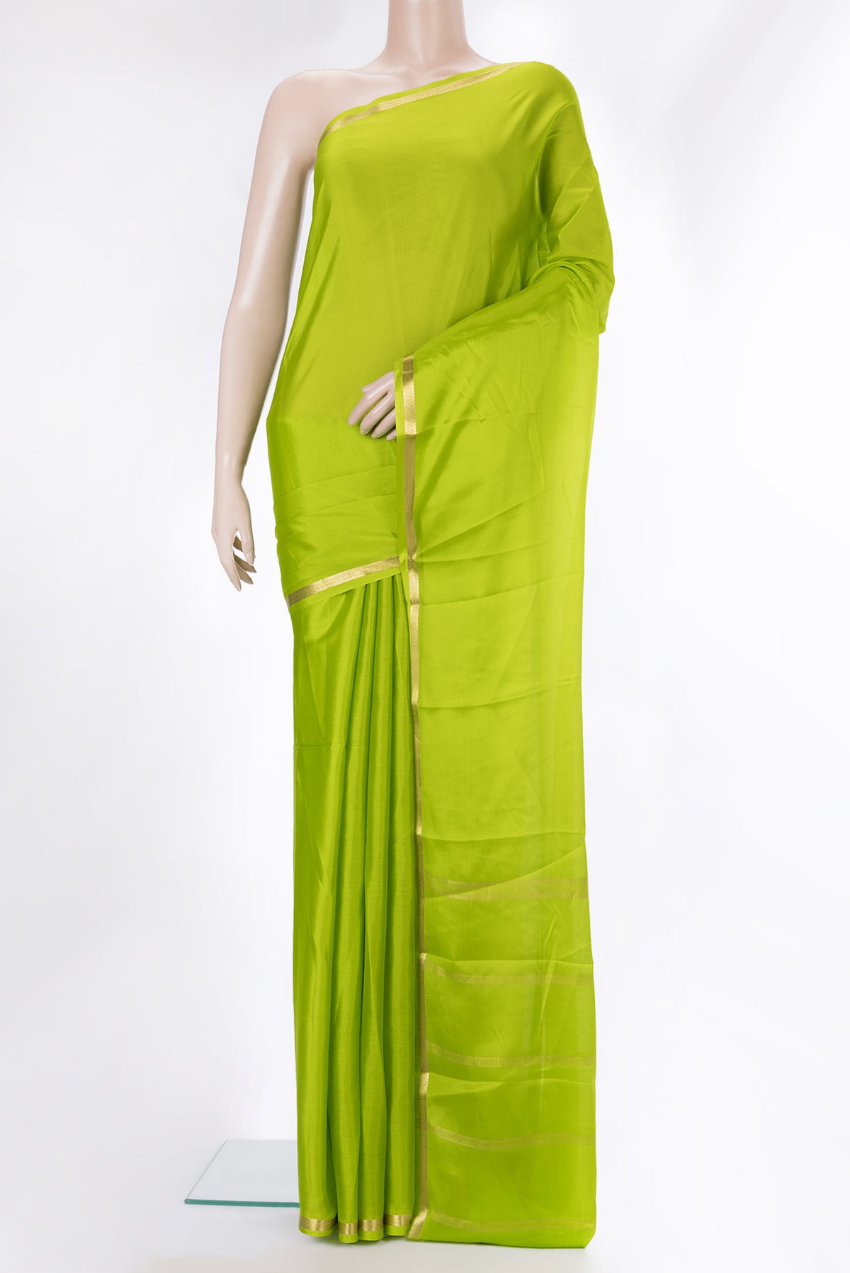Parrot Green Mysore Crepe Saree with Plain Body and Zari Border.  displayed on a mannequin