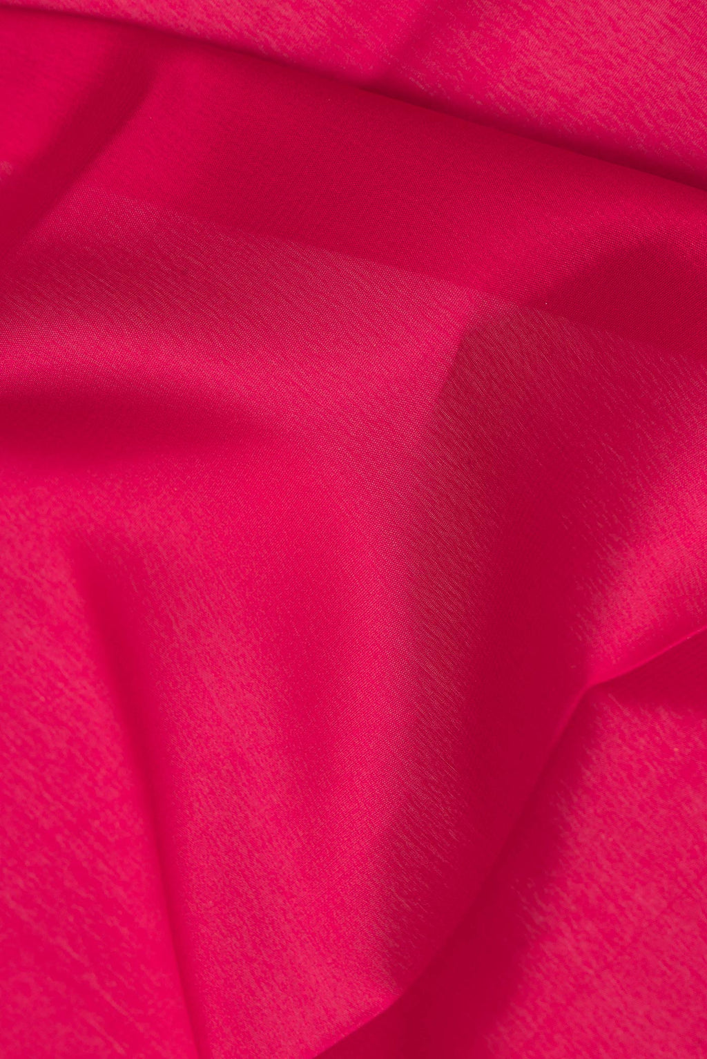 Close up of Red Mysore Crepe Saree with Plain Body and Zari Border.  displaying folds