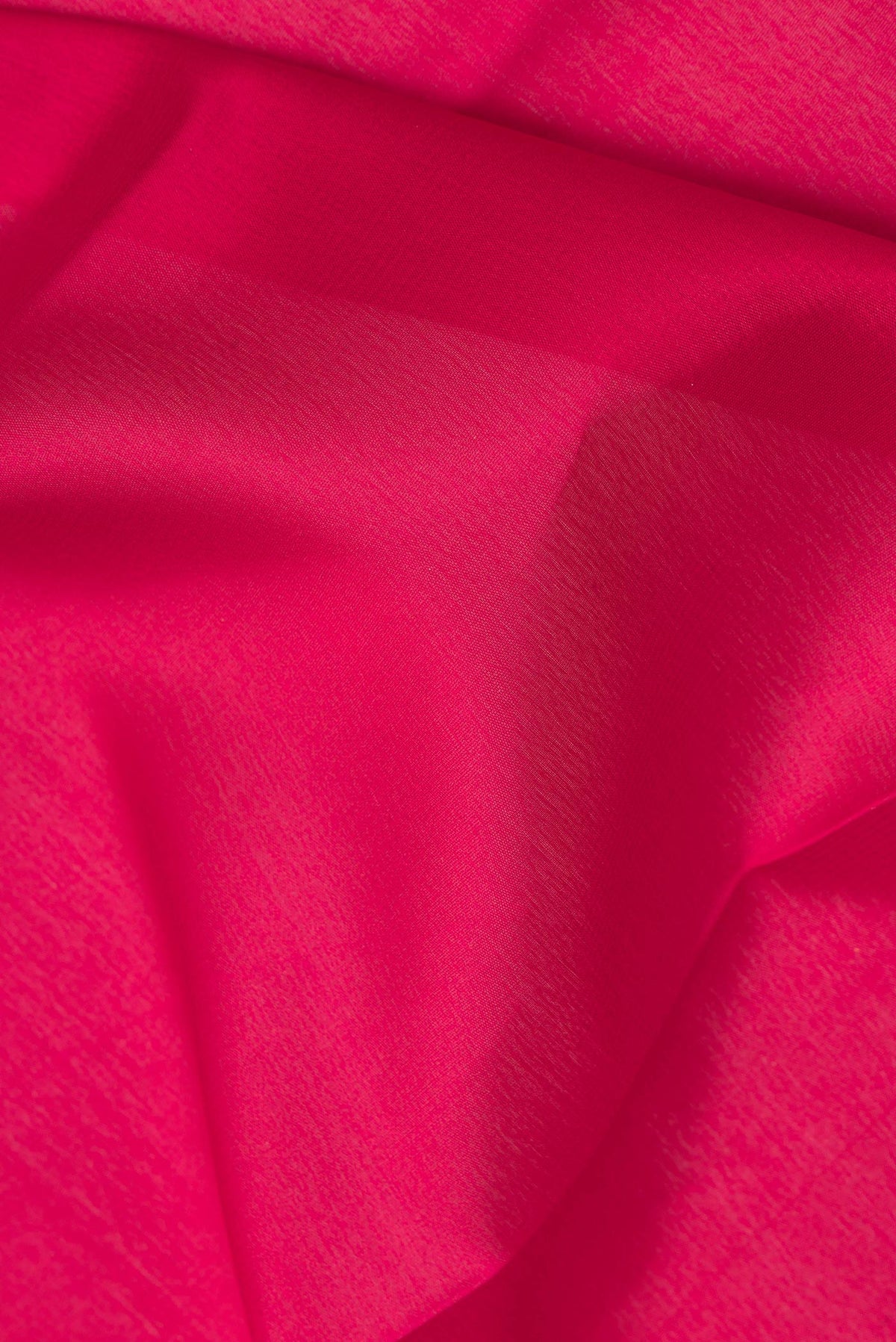 Close up of Red Mysore Crepe Saree with Plain Body and Zari Border.  displaying folds