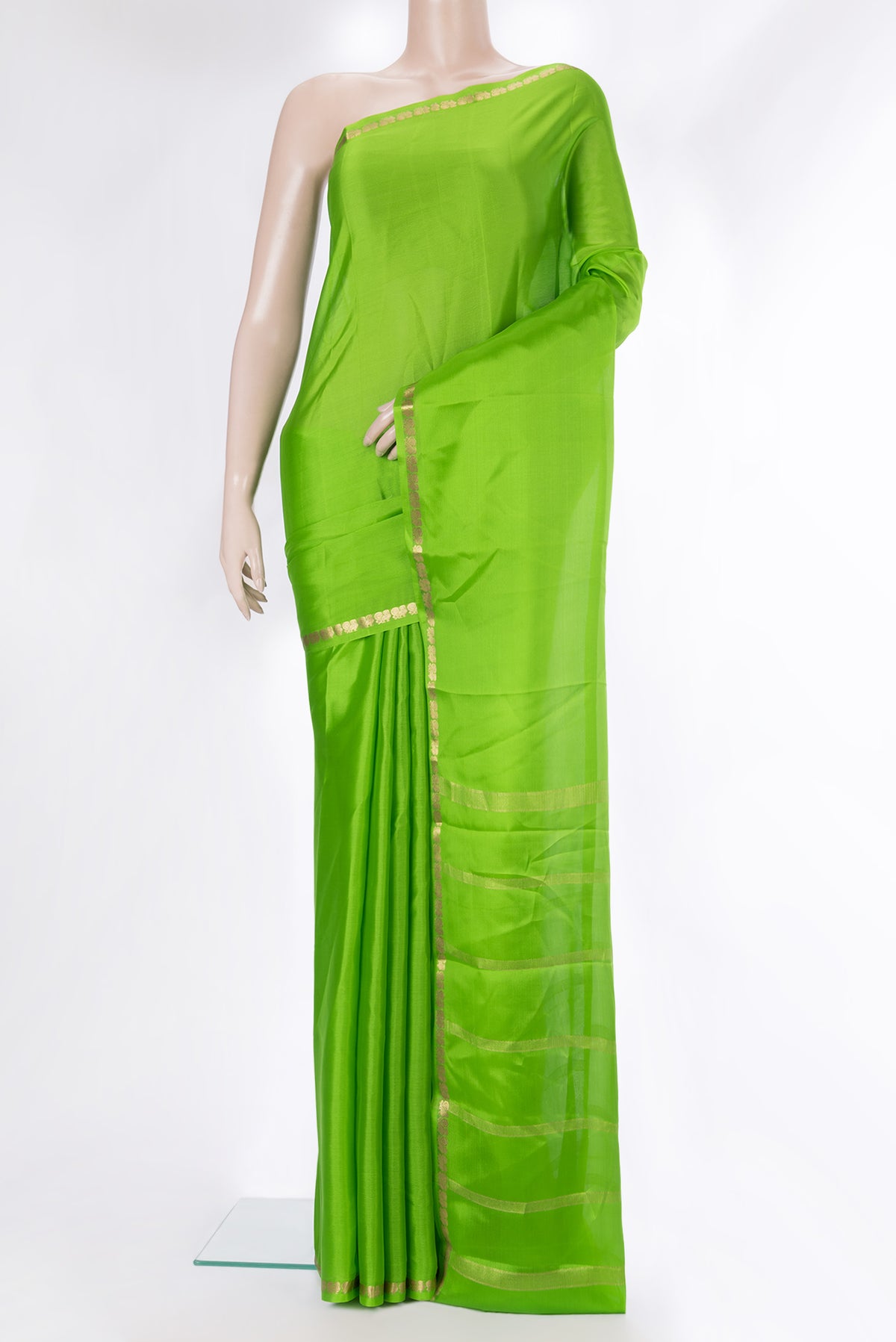 Parrot Green Mysore Crepe Saree with Plain Body and Zari Border.  displayed on a mannequin