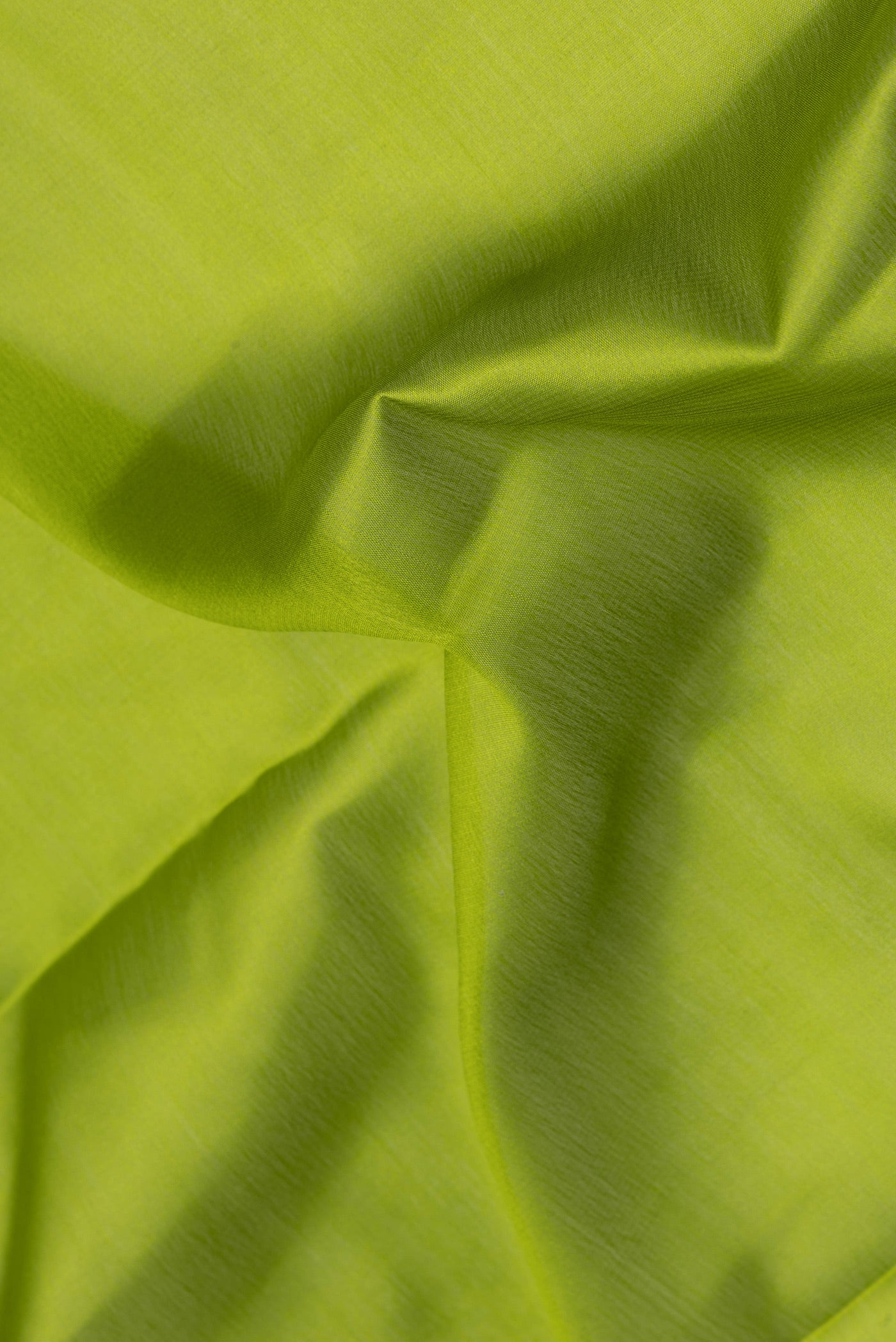 Close up of Mehandi Green Mysore Crepe Saree with Plain Body and Zari Border.  displaying folds