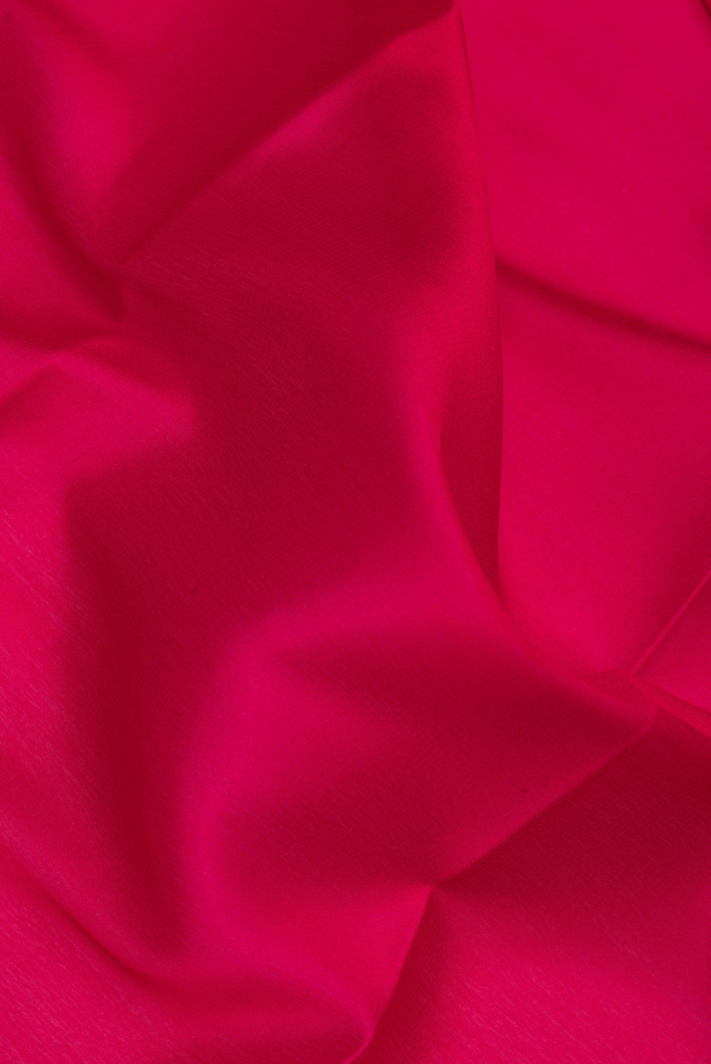 Close up of Dark Pink Mysore Silk Saree with Plain Body and Zari Border.  displaying folds