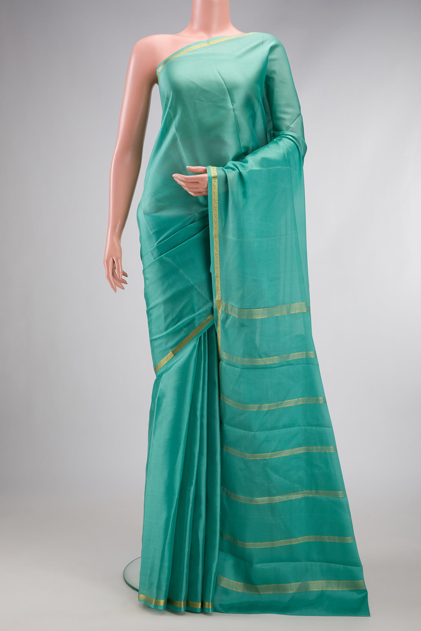 Sky Blue Mysore Crepe Saree with Plain Body and Zari Border.  displayed on a mannequin