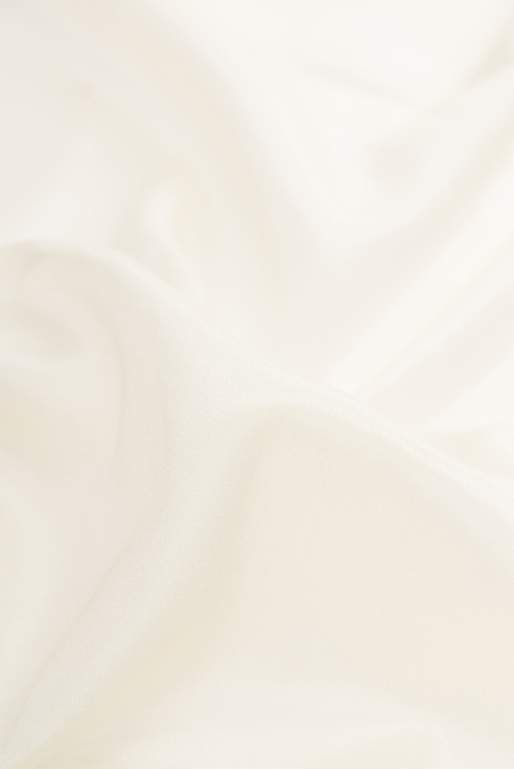 Close up of Off White Dual Tone Mysore Silk Saree with Plain Body and Zari Border.  displaying folds
