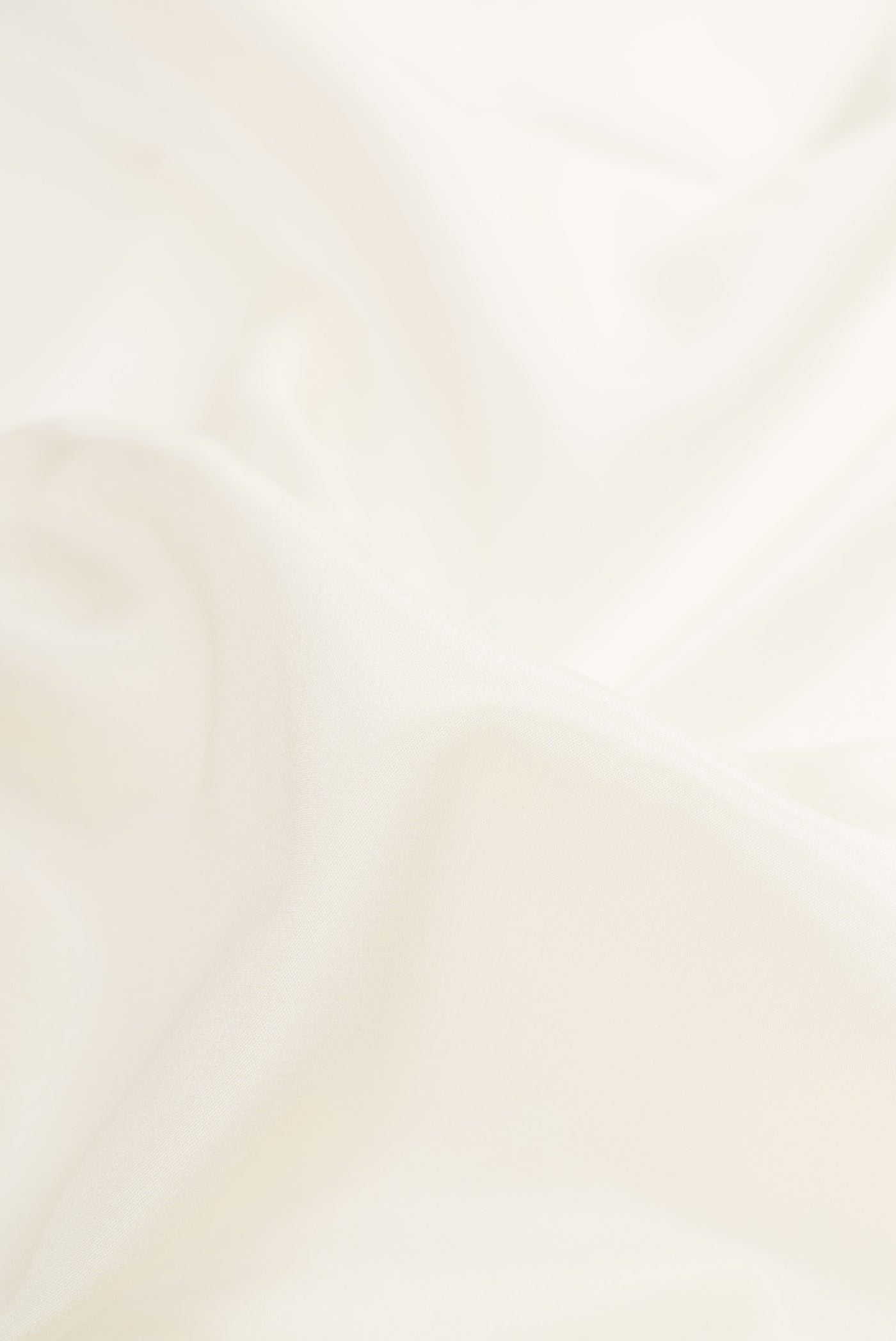 Close up of Off White Dual Tone Mysore Silk Saree with Plain Body and Zari Border.  displaying folds