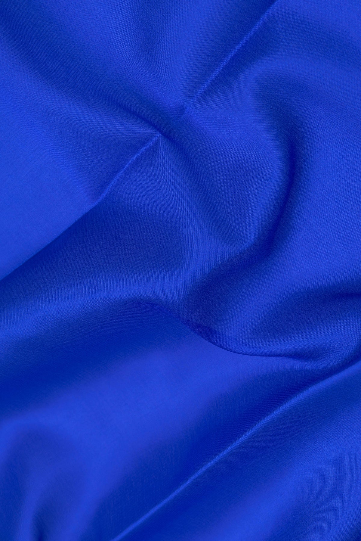 Close up of Royal Blue Dual Tone Mysore Silk Saree with Plain Body and Zari Border.  displaying folds