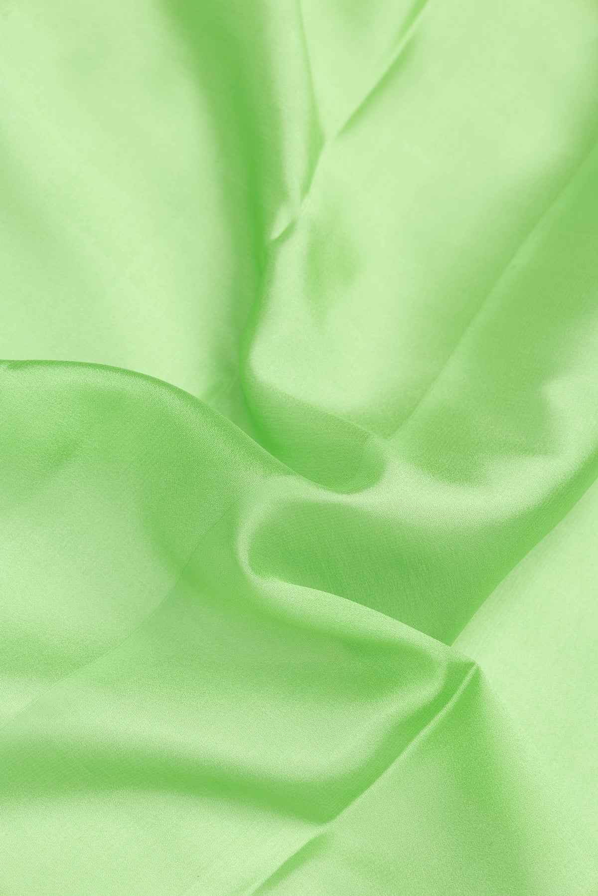 Close up of Parrot Green Dual Tone Mysore Silk Saree with Plain Body and Zari Border.  displaying folds