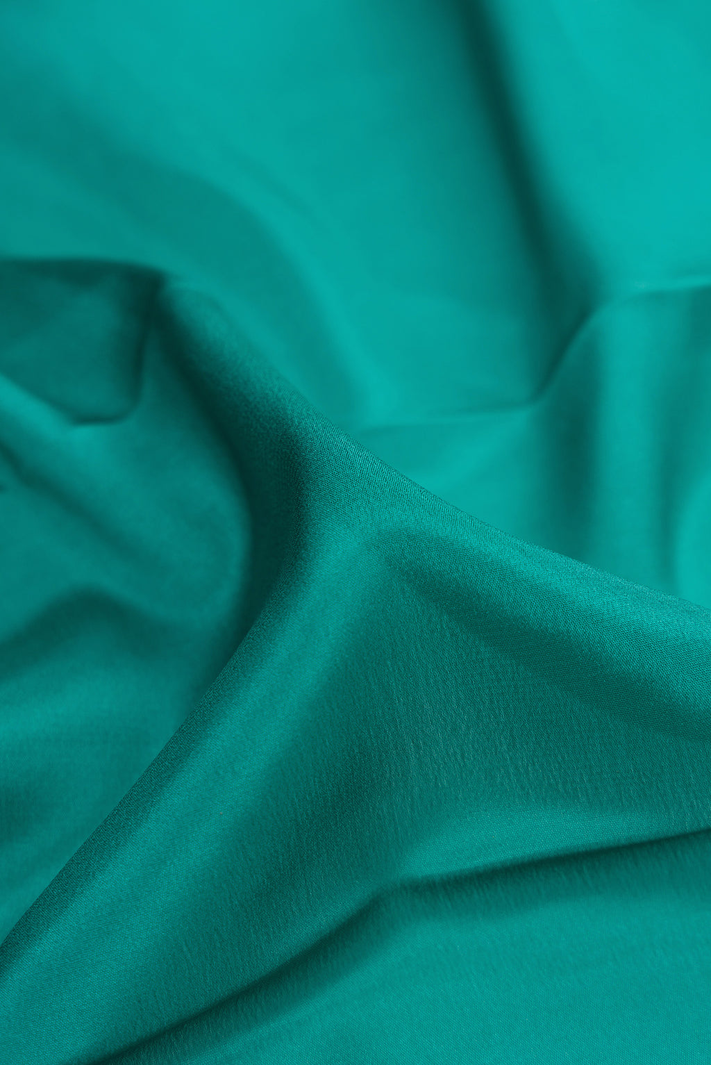 Close up of Green Dual Tone Mysore Silk Saree with Plain Body and Zari Border.  displaying folds