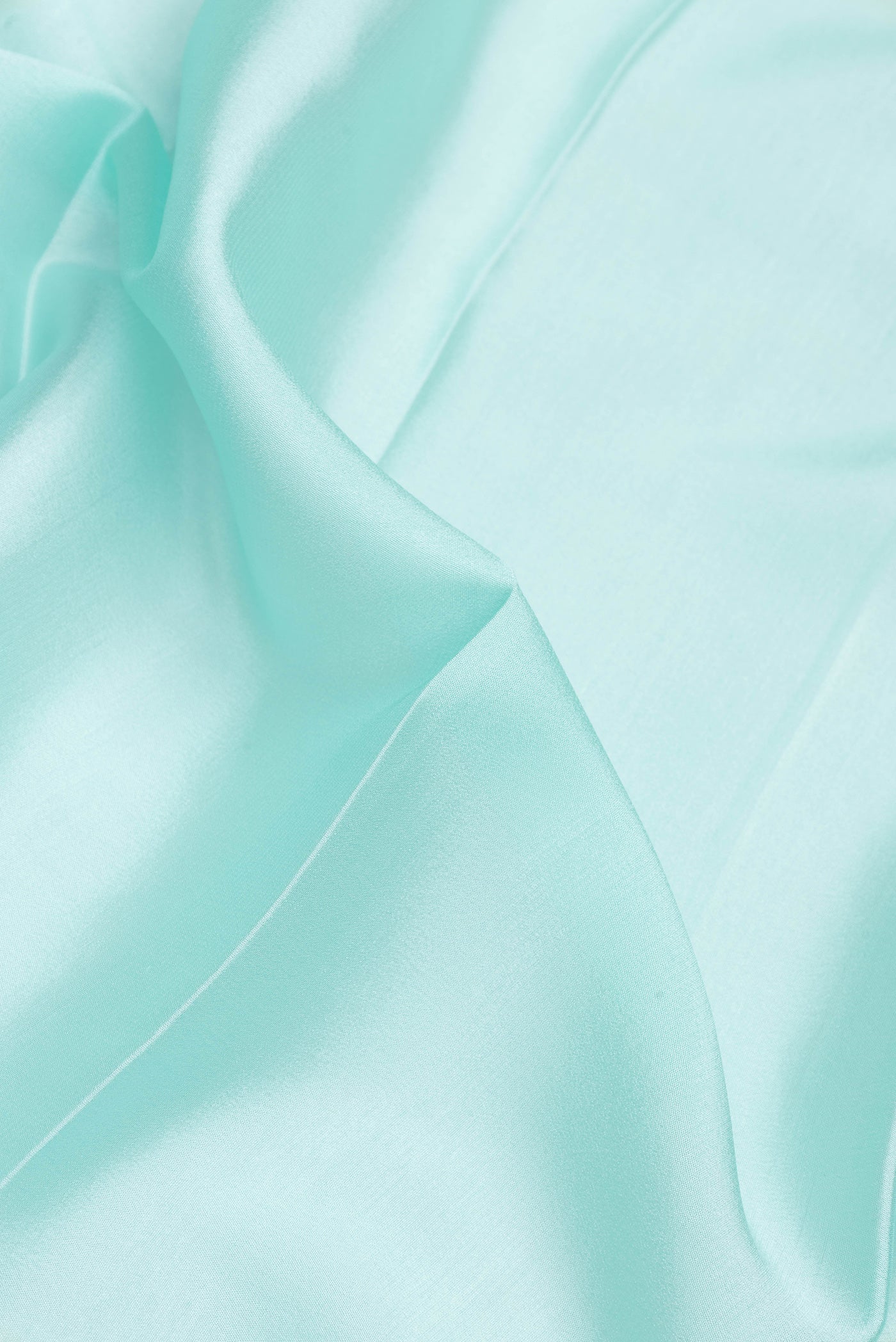 Close up of Light Blue Dual Tone Mysore Silk Saree with Plain Body and Zari Border.  displaying folds