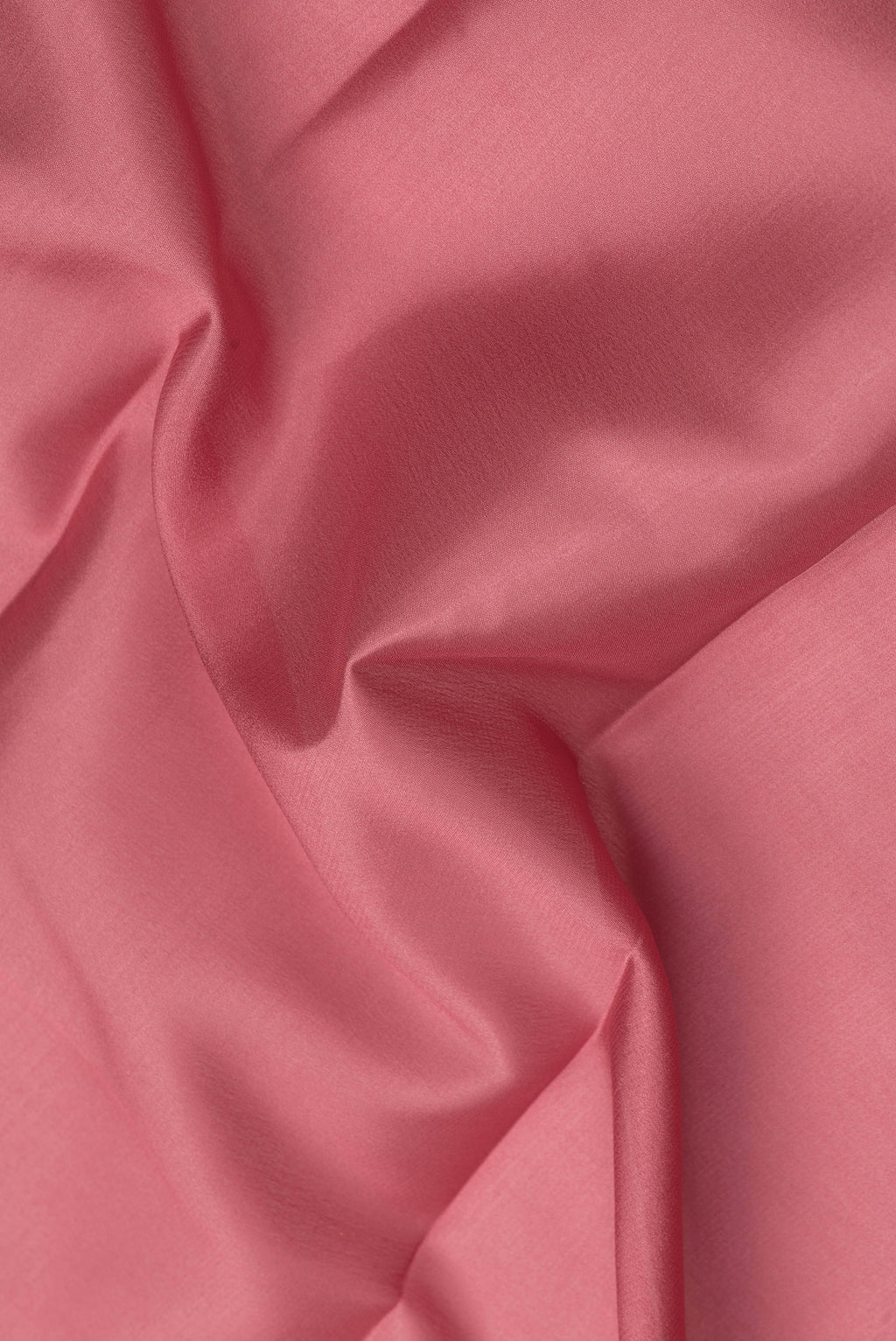 Close up of Coral Mysore Crepe Saree with Plain Body and Zari Border.  displaying folds