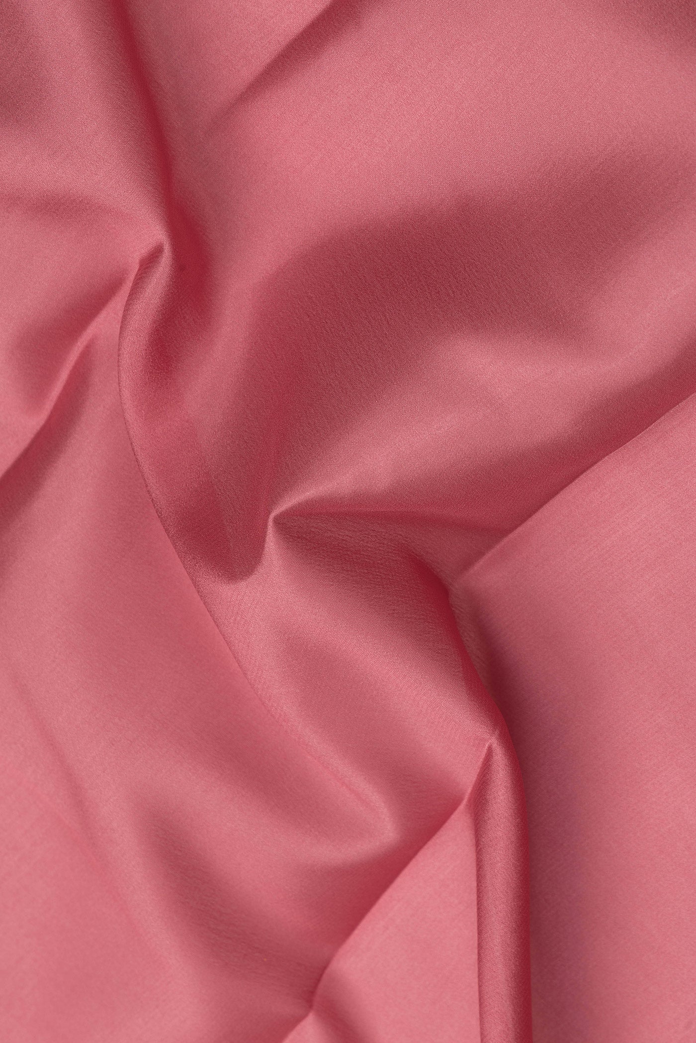 Close up of Coral Mysore Crepe Saree with Plain Body and Zari Border.  displaying folds