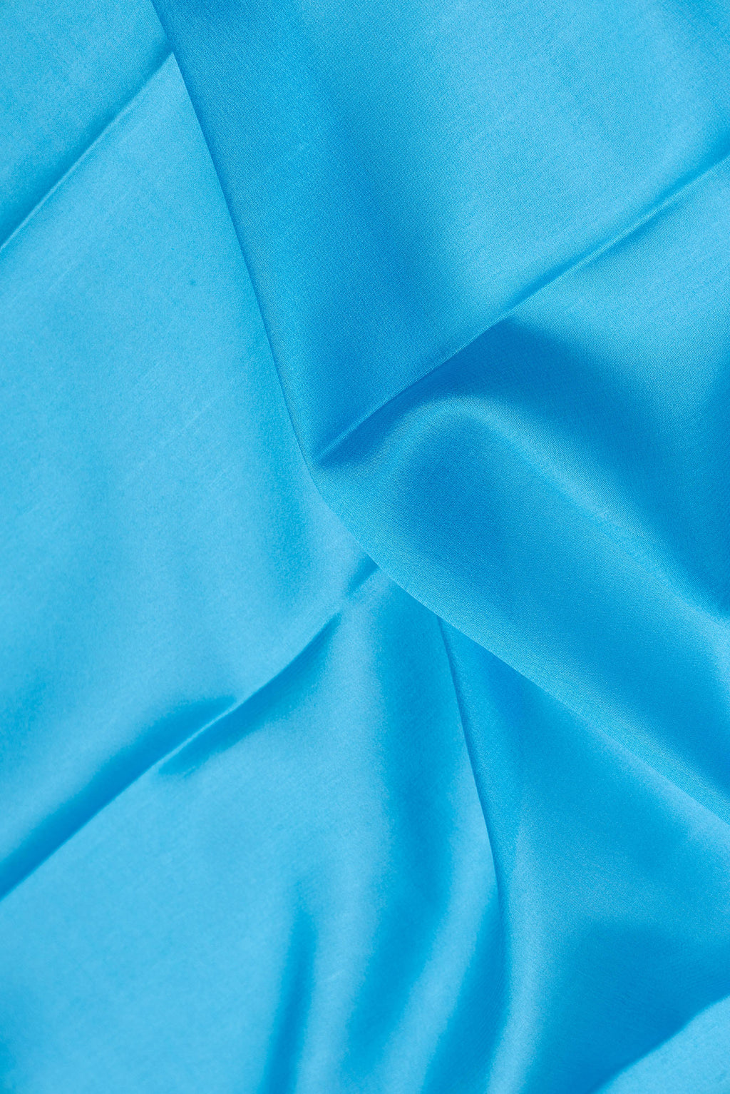 Close up of Sky Blue Dual Tone Mysore Silk Saree with Plain Body and Zari Border.  displaying folds