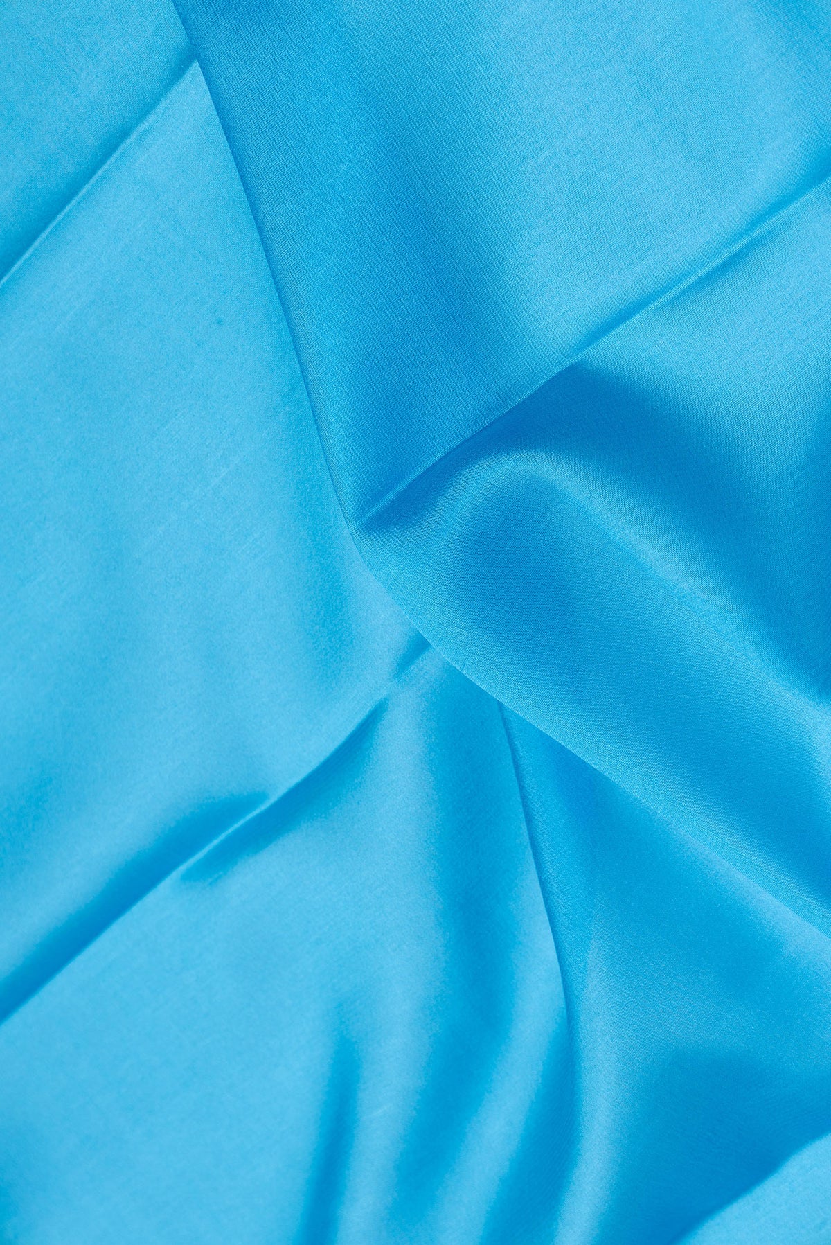 Close up of Sky Blue Dual Tone Mysore Silk Saree with Plain Body and Zari Border.  displaying folds