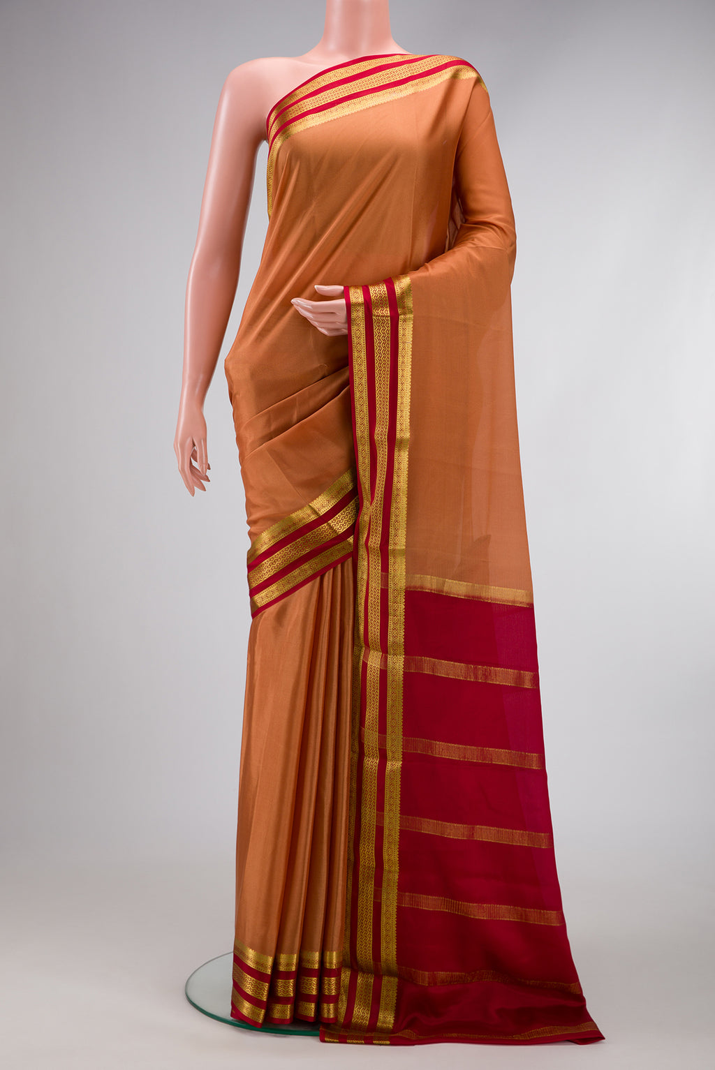 Gold Dual Tone Mysore Silk Saree with Plain Body and Zari Border.  displayed on a mannequin