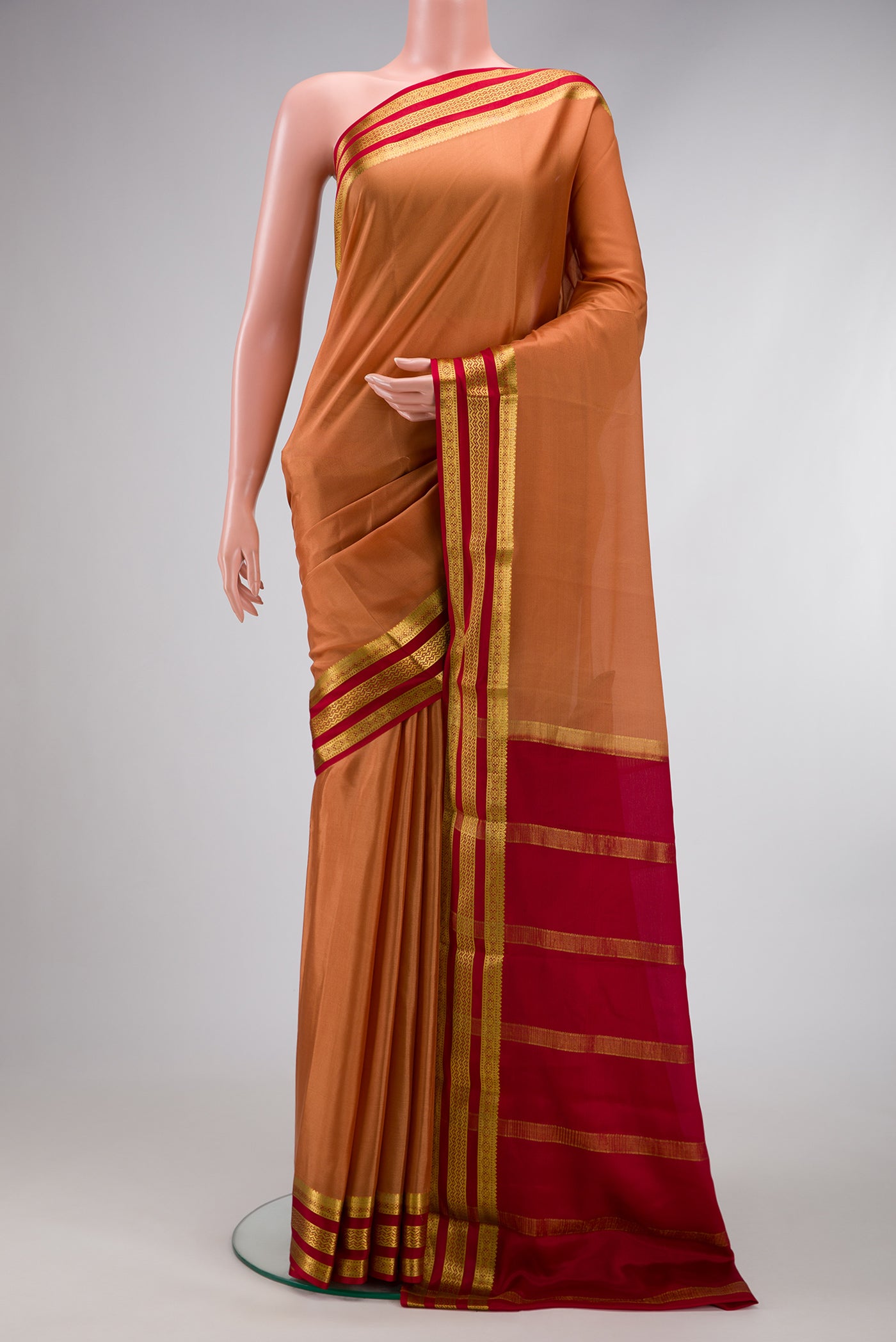 Gold Dual Tone Mysore Silk Saree with Plain Body and Zari Border.  displayed on a mannequin