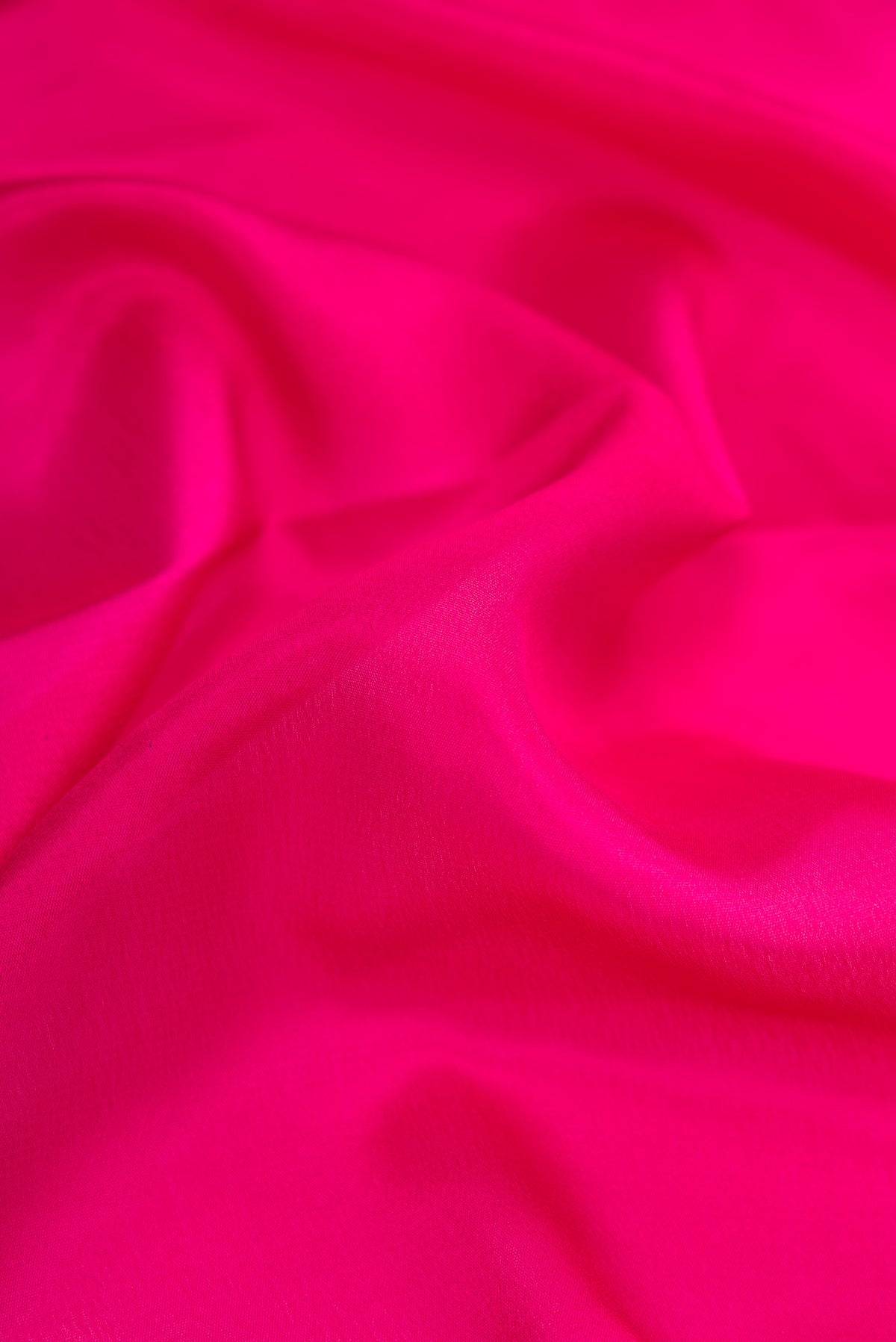 Close up of Magenta Dual Tone Mysore Silk Saree with Plain Body and Fancy Border.  displaying folds