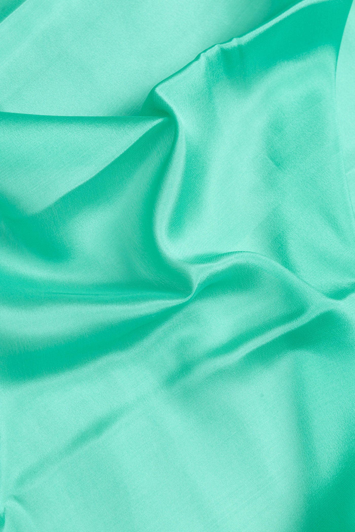 Close up of Sea Green Dual Tone Mysore Crepe Saree with Plain Body and Zari Border.  displaying folds