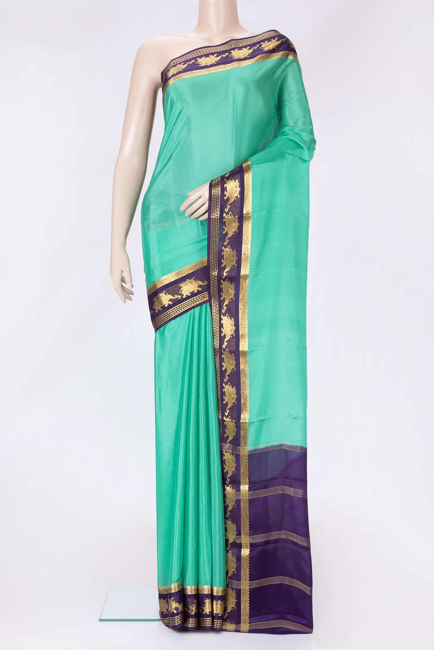 Sea Green Dual Tone Mysore Crepe Saree with Plain Body and Zari Border.  displayed on a mannequin
