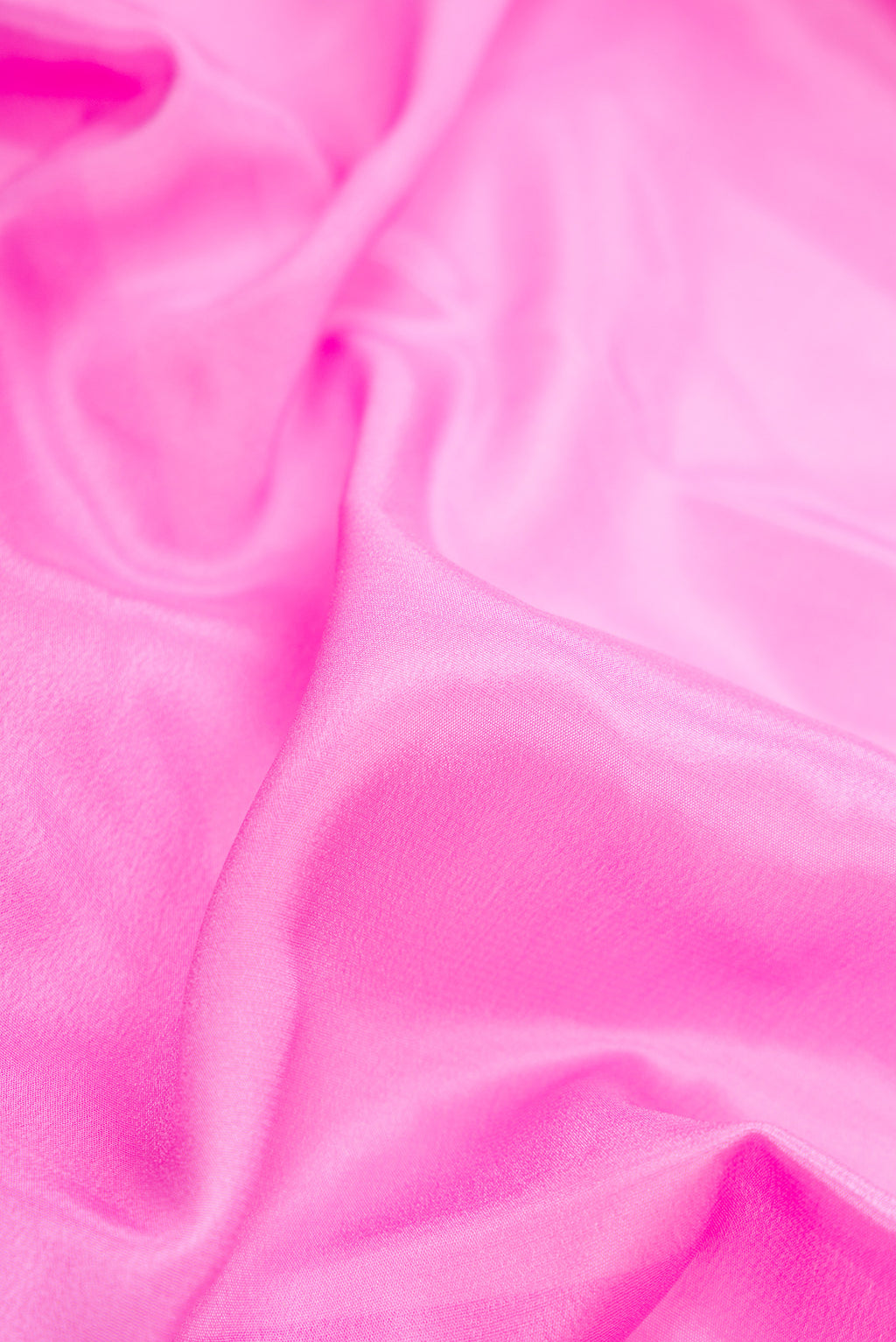 Close up of Pink Dual Tone Mysore Silk Saree with Plain Body and Fancy Border.  displaying folds