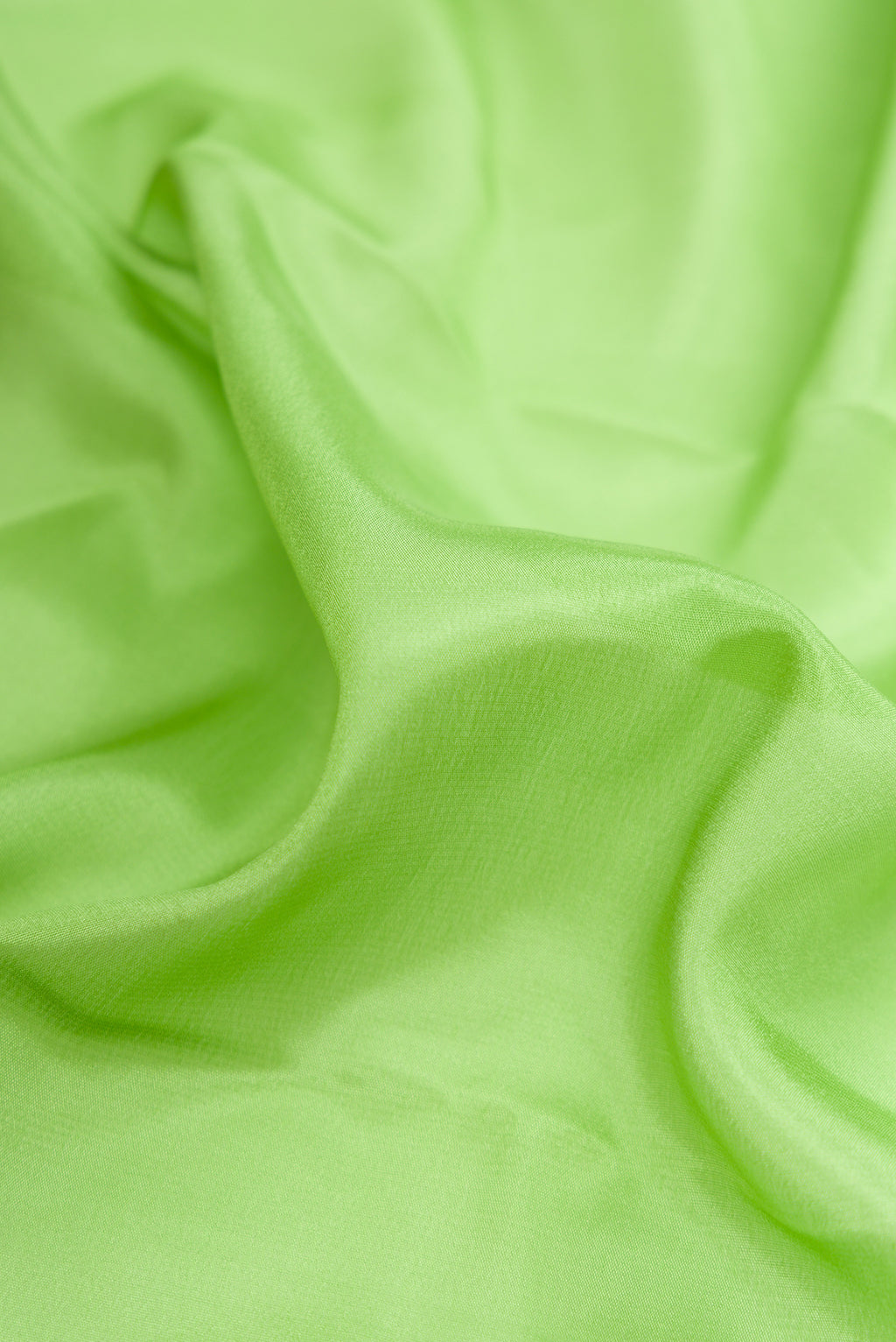 Close up of Parrot Green Dual Tone Mysore Silk Saree with Plain Body and Fancy Border.  displaying folds