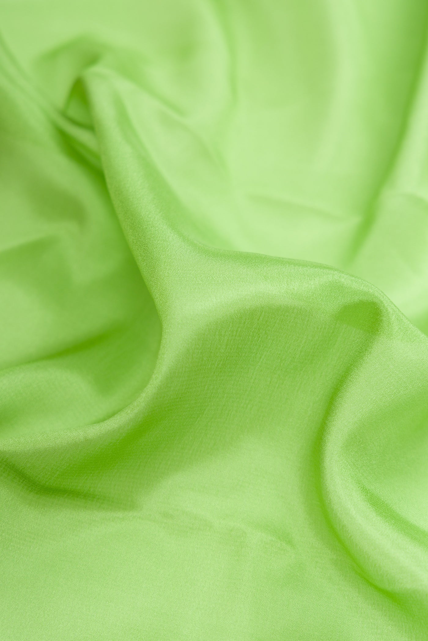 Close up of Parrot Green Dual Tone Mysore Silk Saree with Plain Body and Fancy Border.  displaying folds
