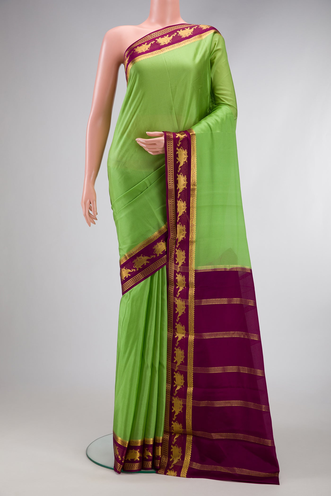 Parrot Green Dual Tone Mysore Silk Saree with Plain Body and Fancy Border.  displayed on a mannequin