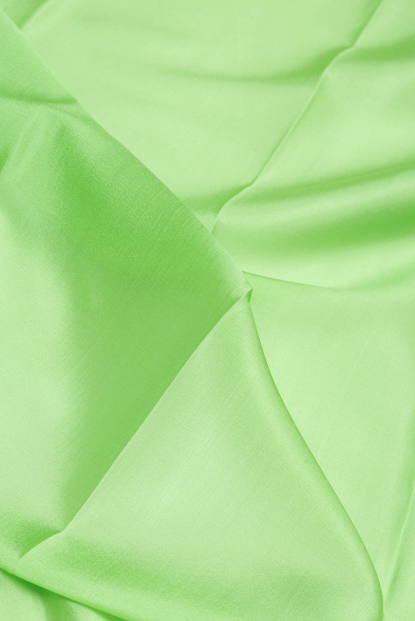Close up of Pista Green Mysore Silk Saree with Plain Body and Zari Border.  displaying folds