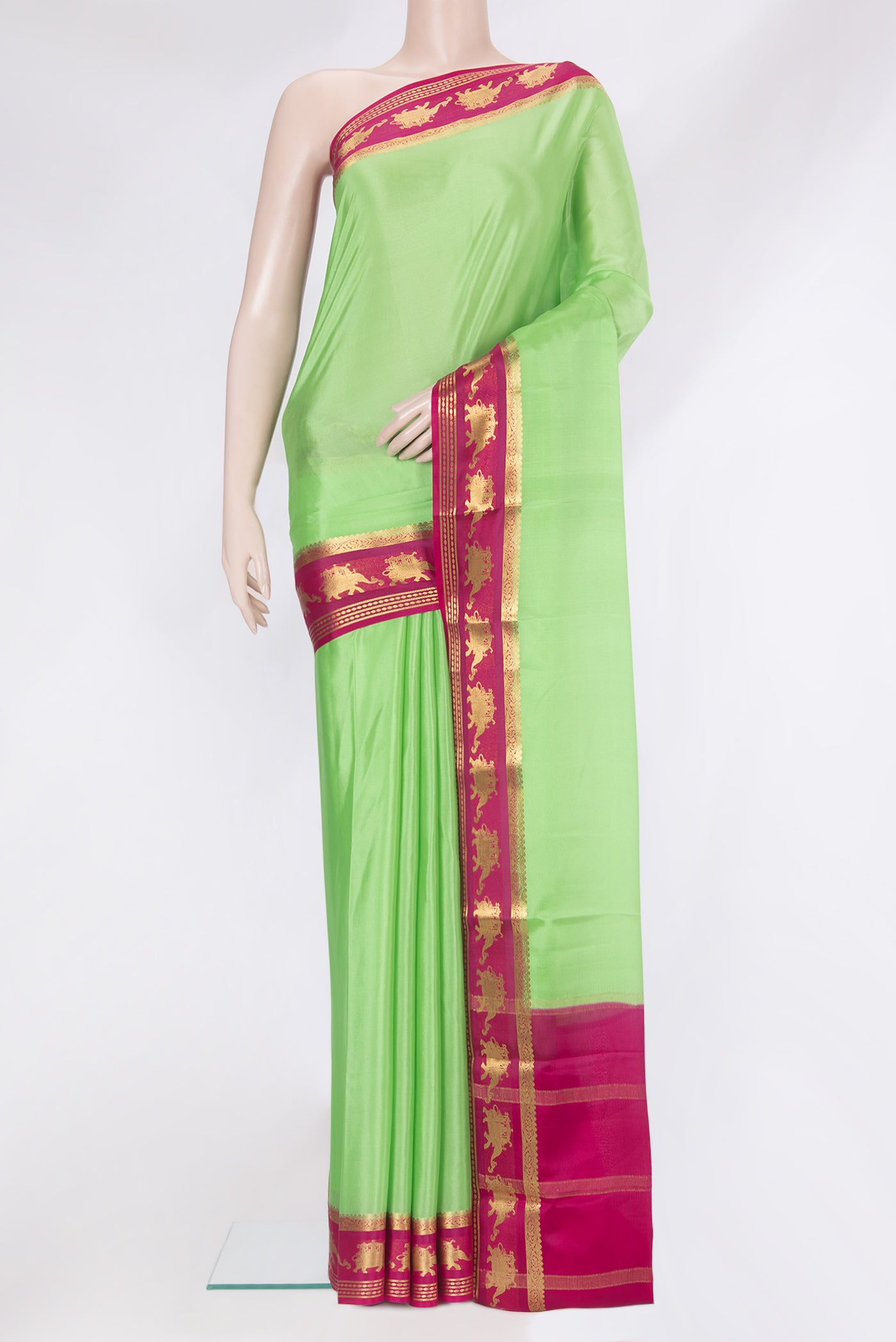 Pista Green Mysore Silk Saree with Plain Body and Zari Border.  displayed on a mannequin