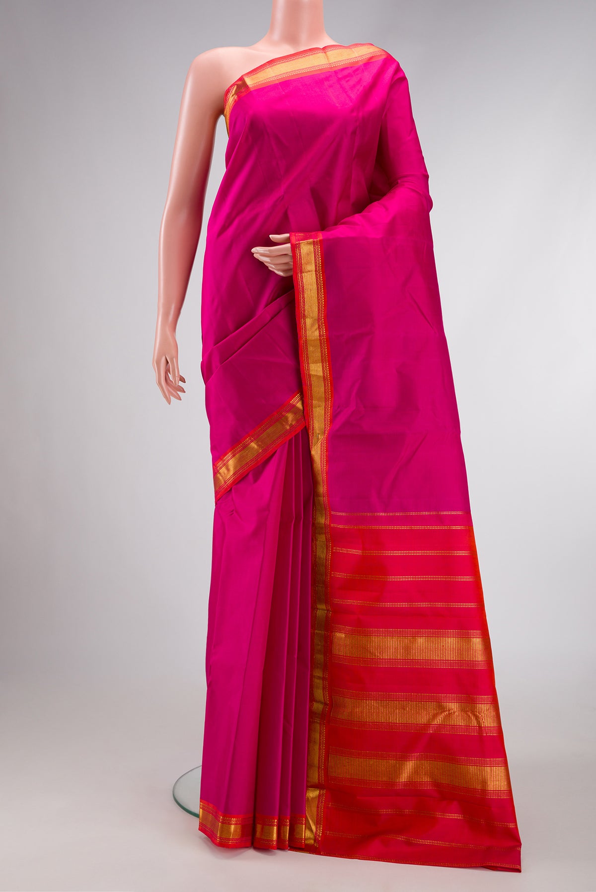 Magenta Dual Tone Kanjivaram Silk Saree with Plain Body and Zari Border.  displayed on a mannequin