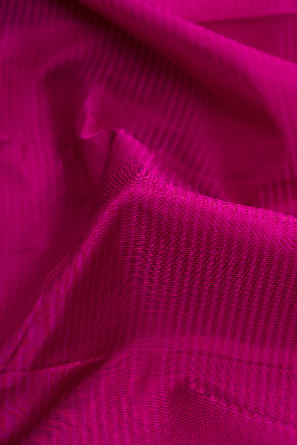 Close up of Purple Dual Tone Kanjivaram Silk Saree with Stripes on the body and Zari Border.  displaying folds