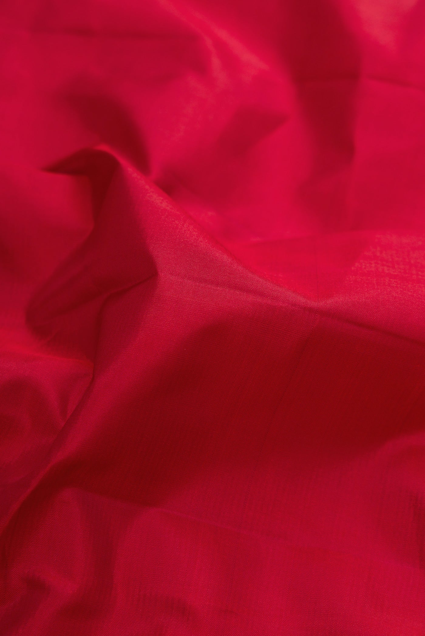 Close up of Maroon Dual Tone Kanchipuram Silk Saree with Plain Body and Zari Border.  displaying folds