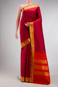 Maroon Dual Tone Kanchipuram Silk Saree with Plain Body and Zari Border.  displayed on a mannequin