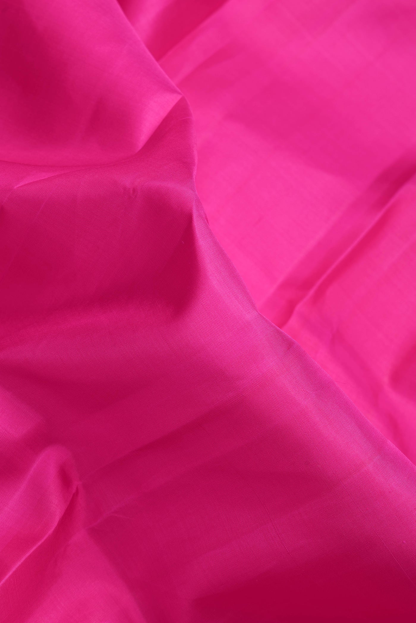 Close up of Pink Dual Tone Kanchipuram Silk Saree with Plain Body and Zari Border.  displaying folds