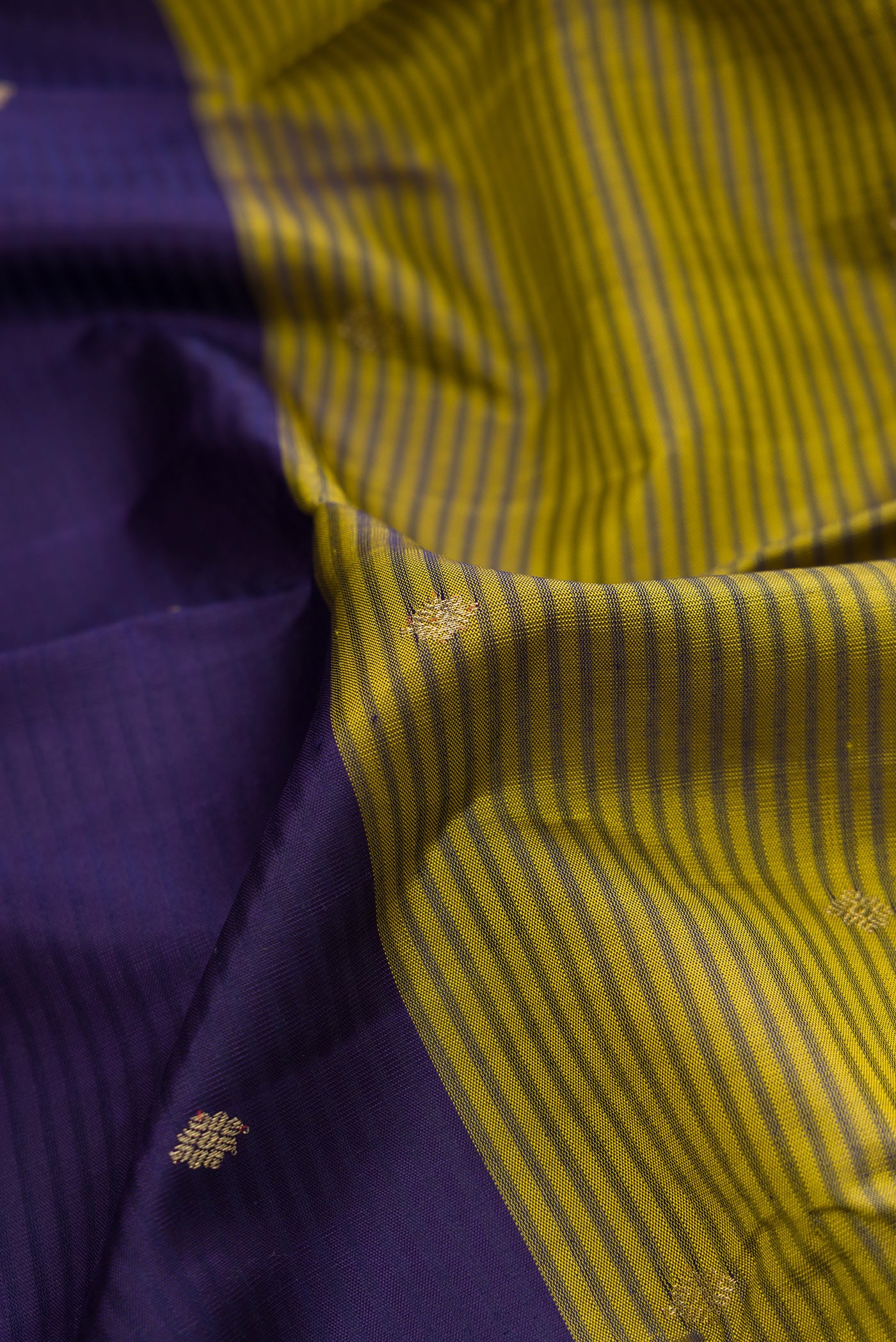 Close up of Peacock Blue, Mehandi Green and Lavender Color Kanchipuram Silk Saree with Stripes on the body and Zari Border.  displaying folds
