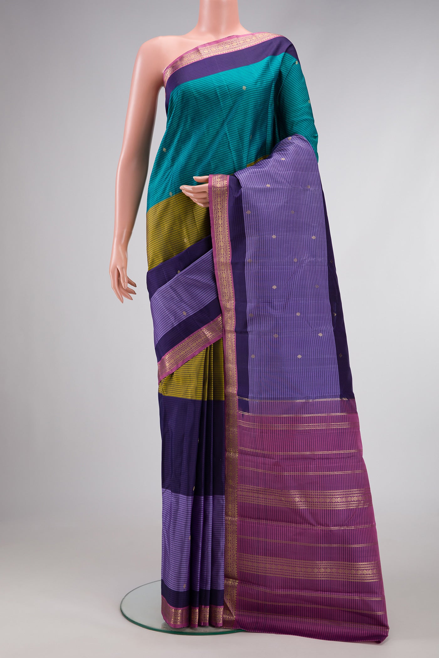 Peacock Blue, Mehandi Green and Lavender Color Kanchipuram Silk Saree with Stripes on the body and Zari Border.  displayed on a mannequin