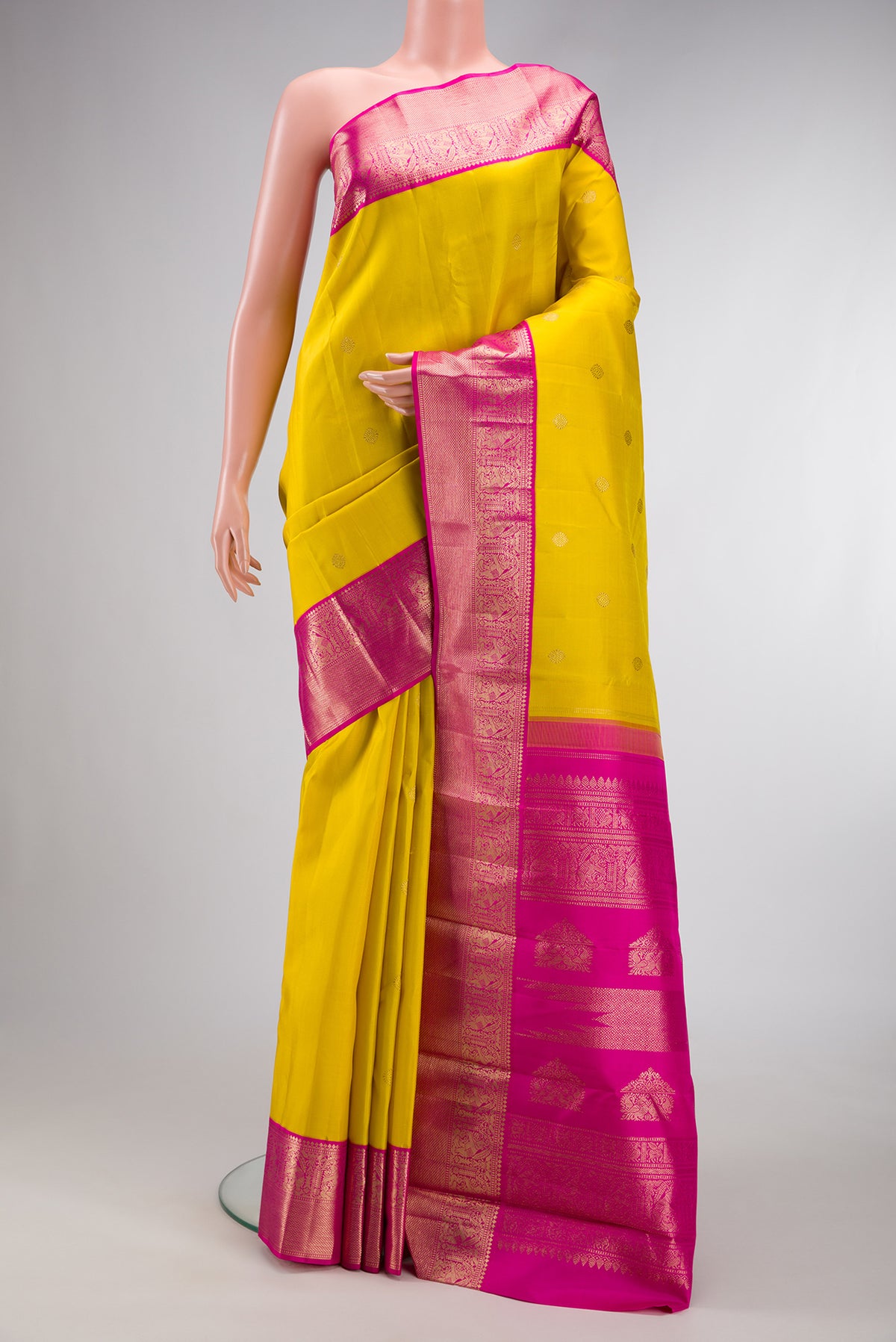 Yellow Dual Tone Kanjivaram Silk Saree with Zari Butta on the body and Zari Border.  displayed on a mannequin