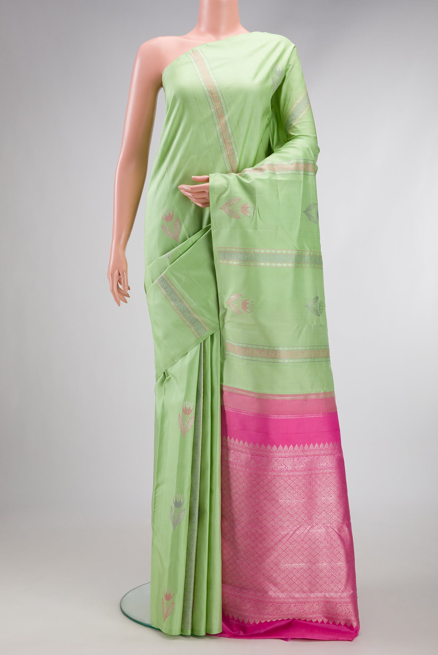 Pista Green Dual Tone Kanjivaram Silk Saree with Zari And Thread Butta on the body and Without Border.  displayed on a mannequin