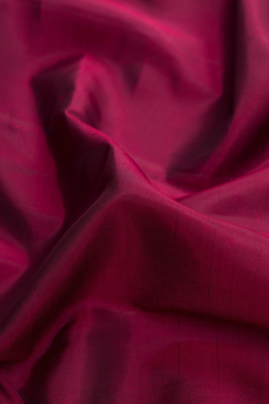 Close up of Pure Silk Pure Zari Maroon Dual Tone Kanjivaram Saree with Plain Body and Zari Border.  displaying folds