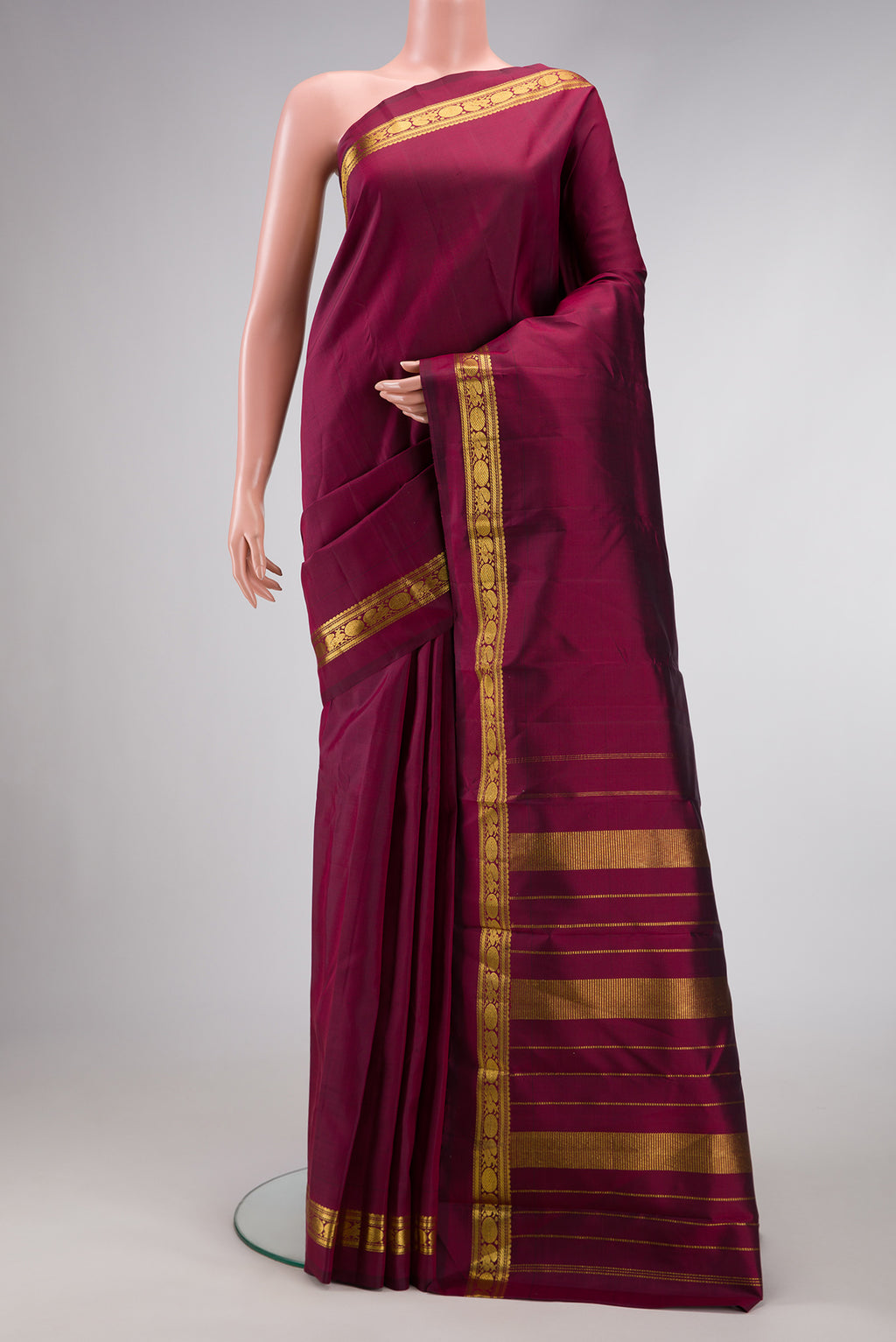 Pure Silk Pure Zari Maroon Dual Tone Kanjivaram Saree with Plain Body and Zari Border.  displayed on a mannequin