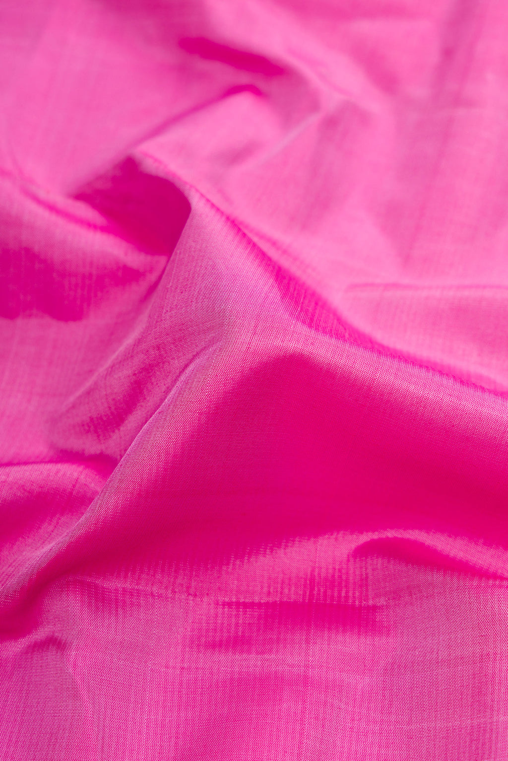 Close up of Pink Dual Tone Kanjivaram Silk Saree with Plain Body and Zari Border.  displaying folds
